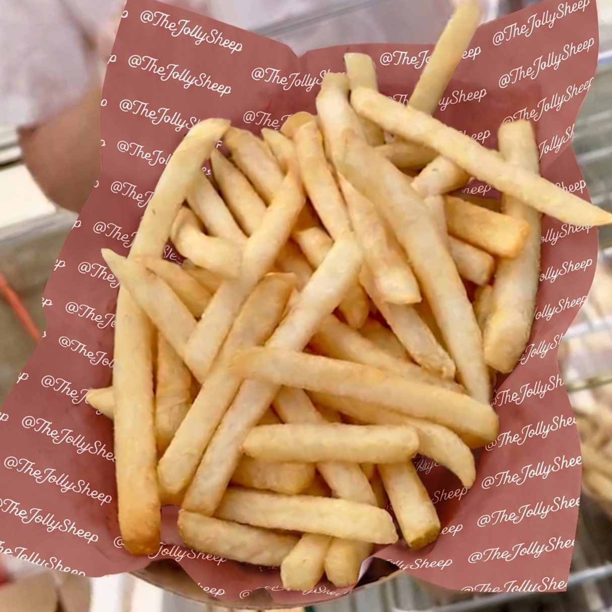 French fries on a tray with a custom food tissue for a Jolly Sheep catering event