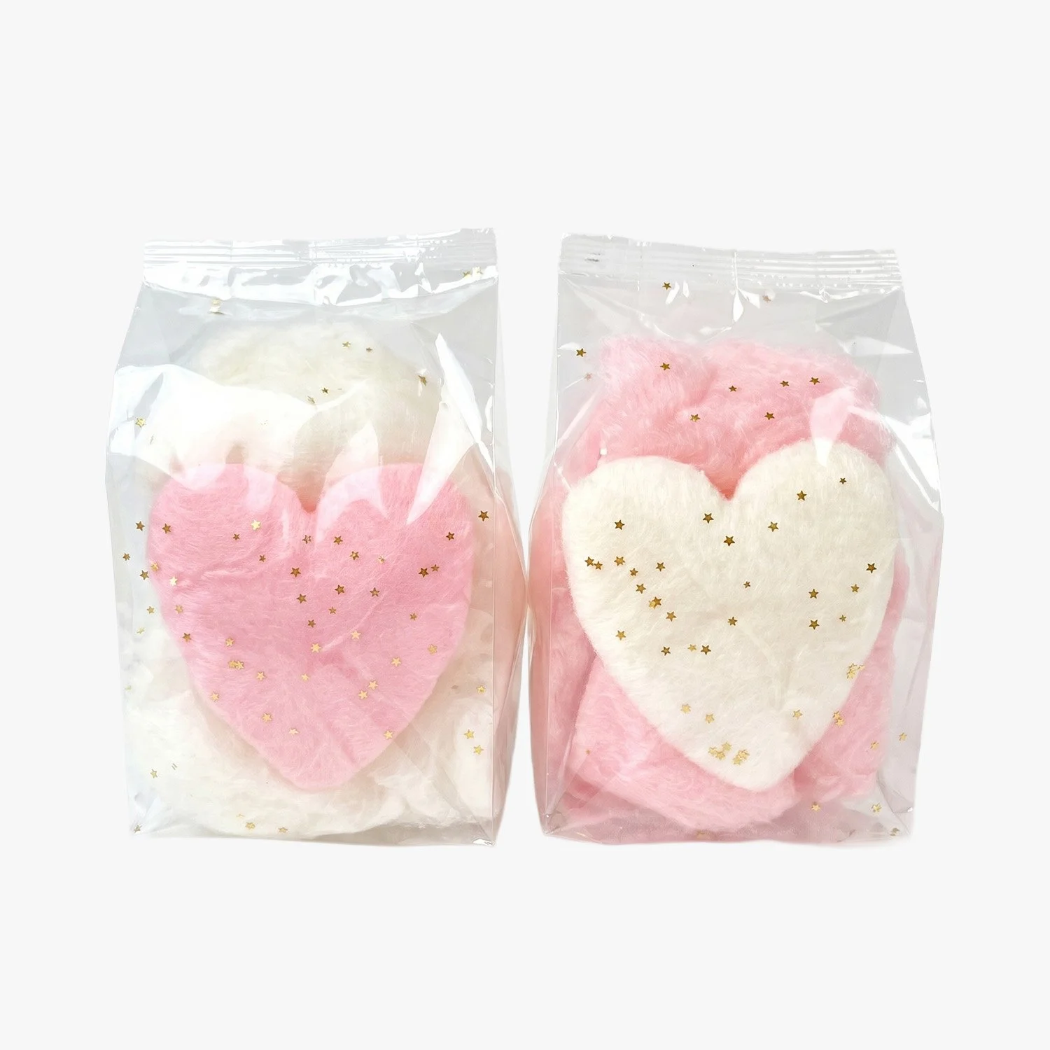 heart shaped cotton candy favors in pink and white with edible gold glitter