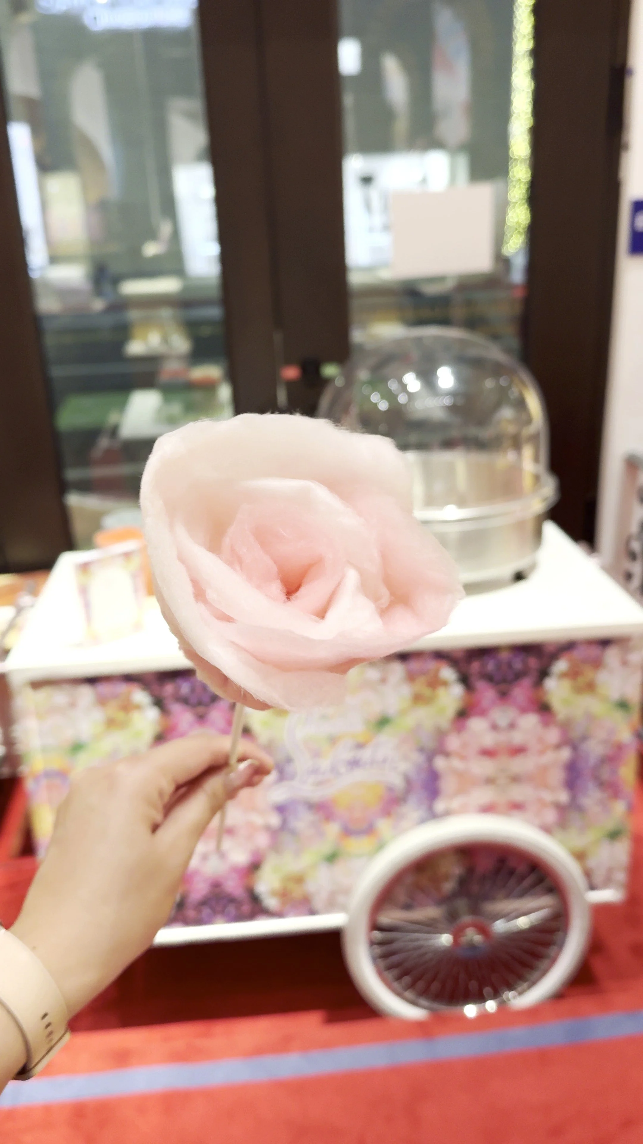 cotton candy on a stick in the shape of a single rose