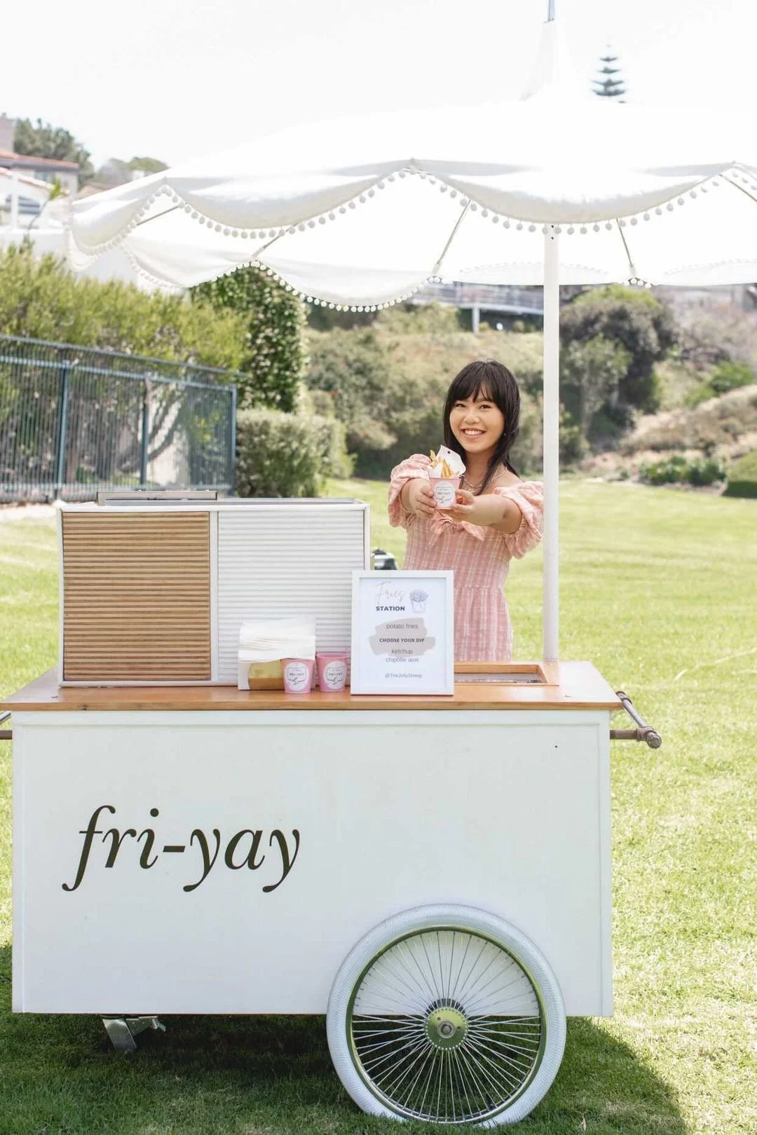 A Jolly Sheep attendant handing fries out at the french fry cart