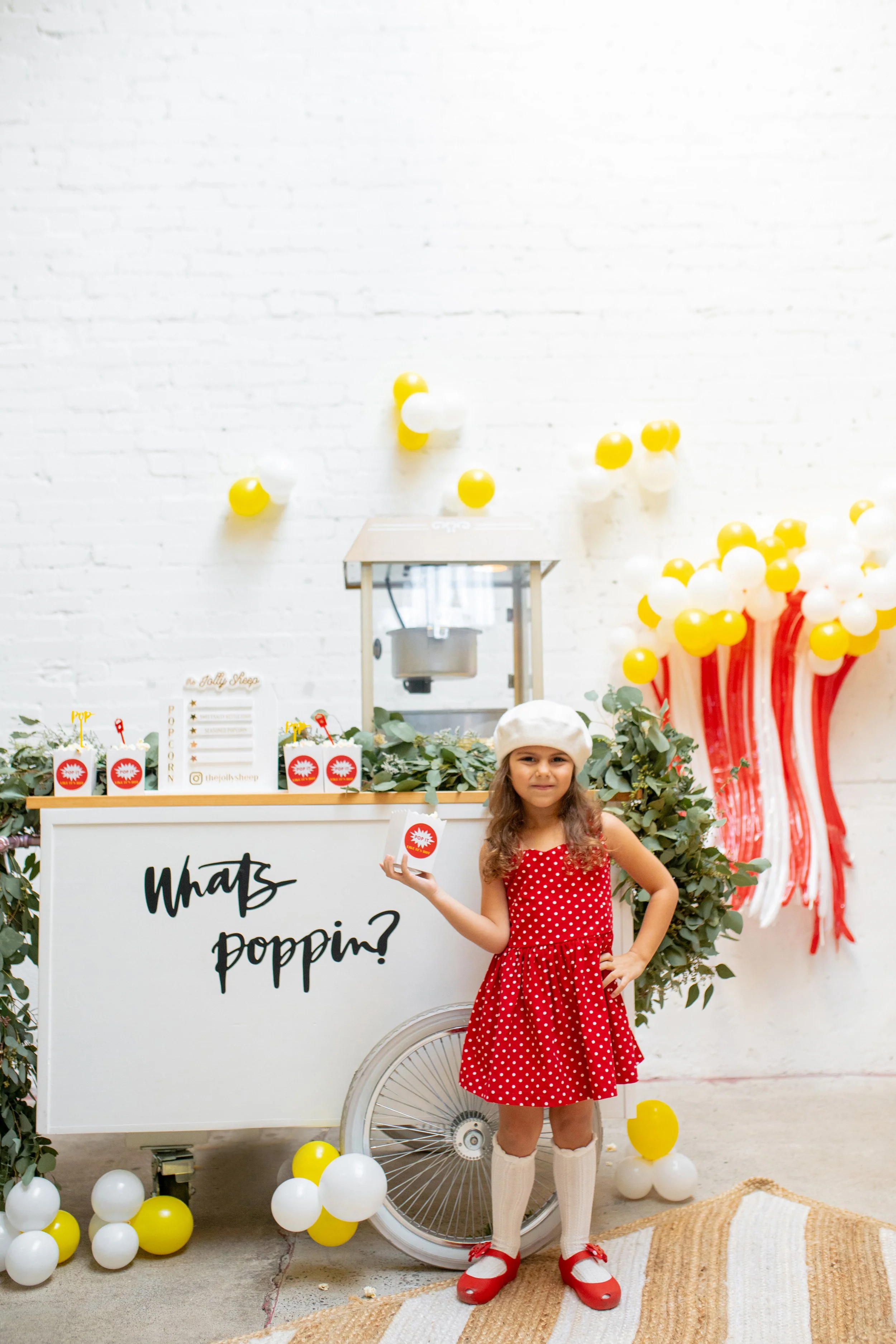 a young girl with attitude staring at the camera while holding up a popcorn box