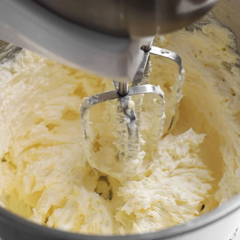 a close up of whipped cream being made in a stand mixer