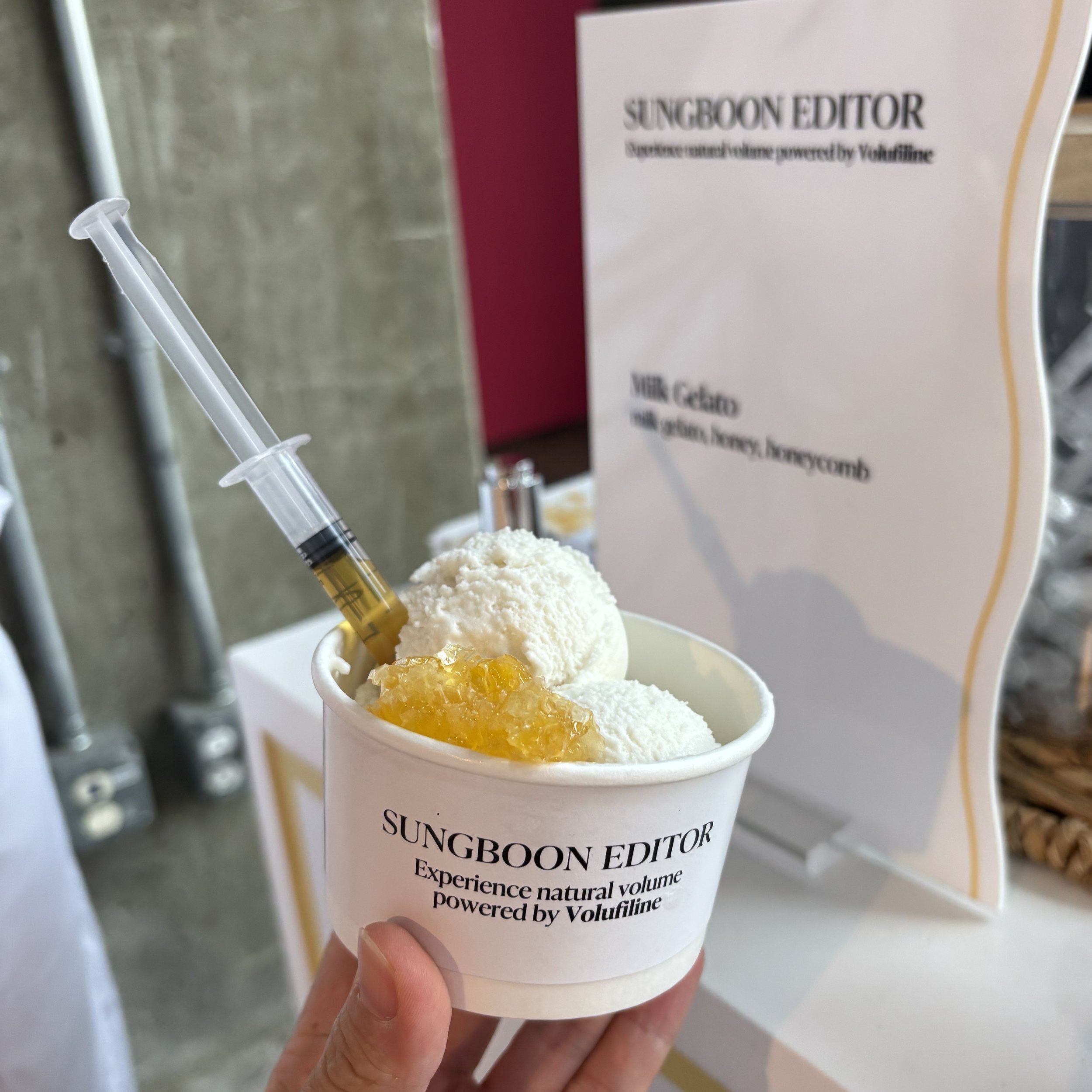 A cup of vanilla gelato with honeycomb and honey in a syringe for a beauty activation