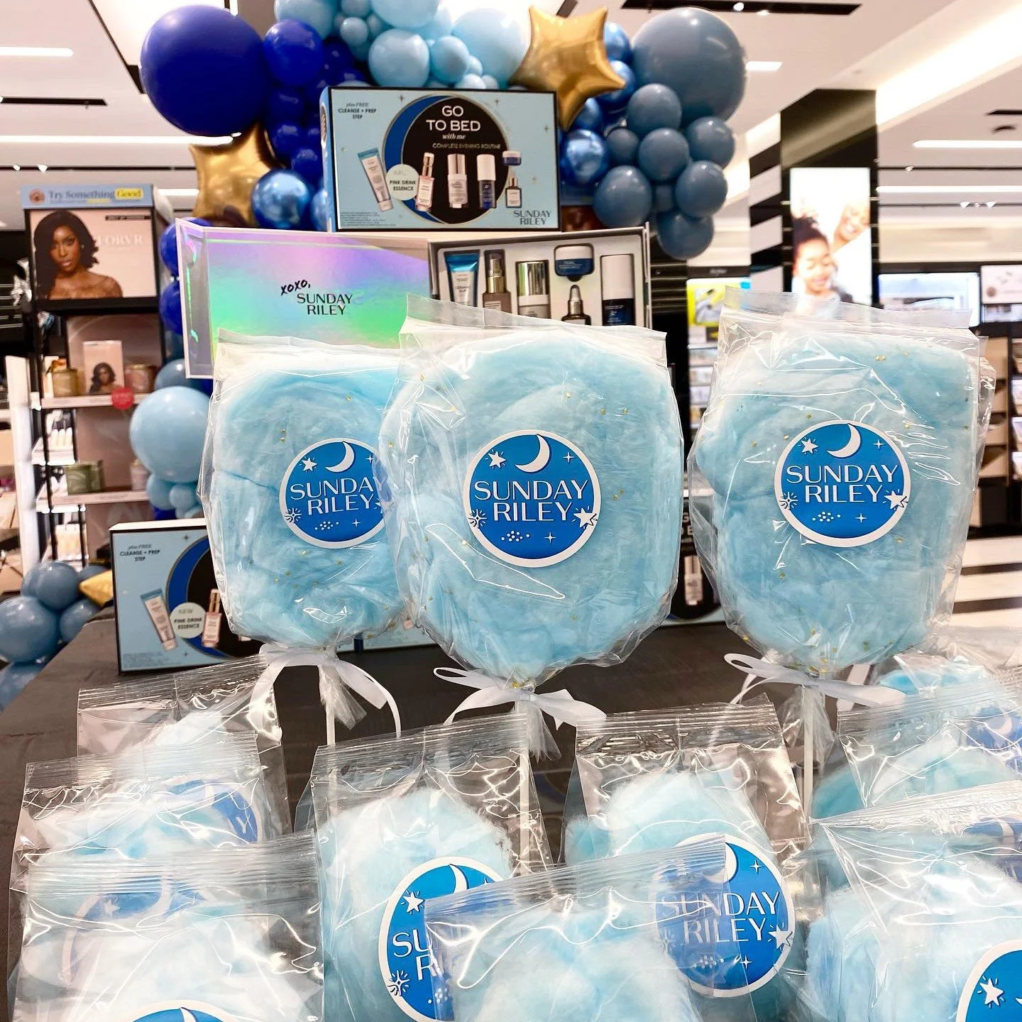white package cotton candy on a stick displayed in a sephora store for a sunday riley activation