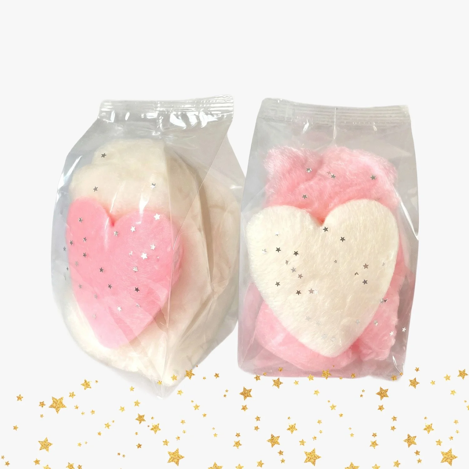 a pair of heart shaped cotton candy favor bags with glitter accent in the lower foreground