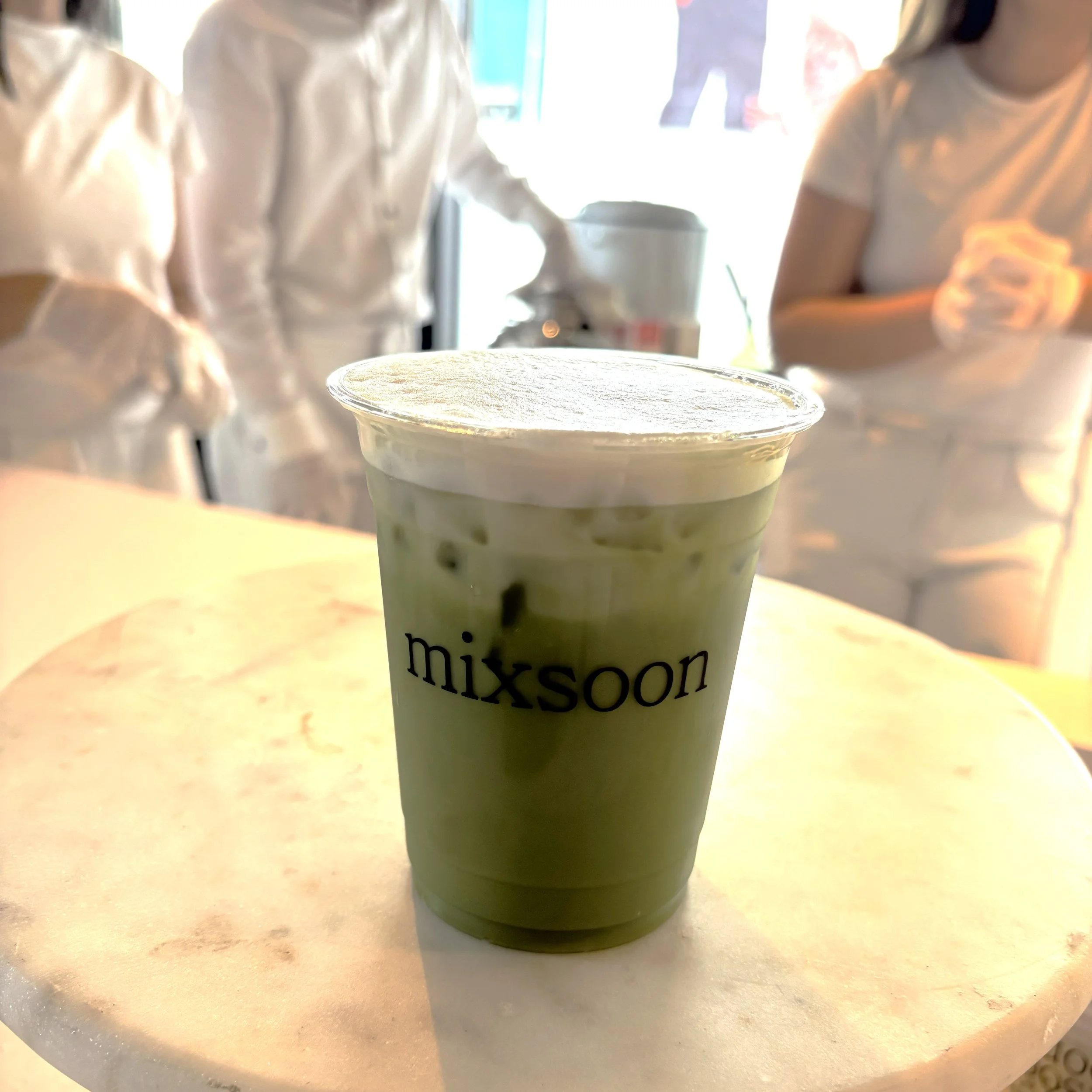 a matcha cup with a custom mixsoon logo at a tiktok k beauty activation