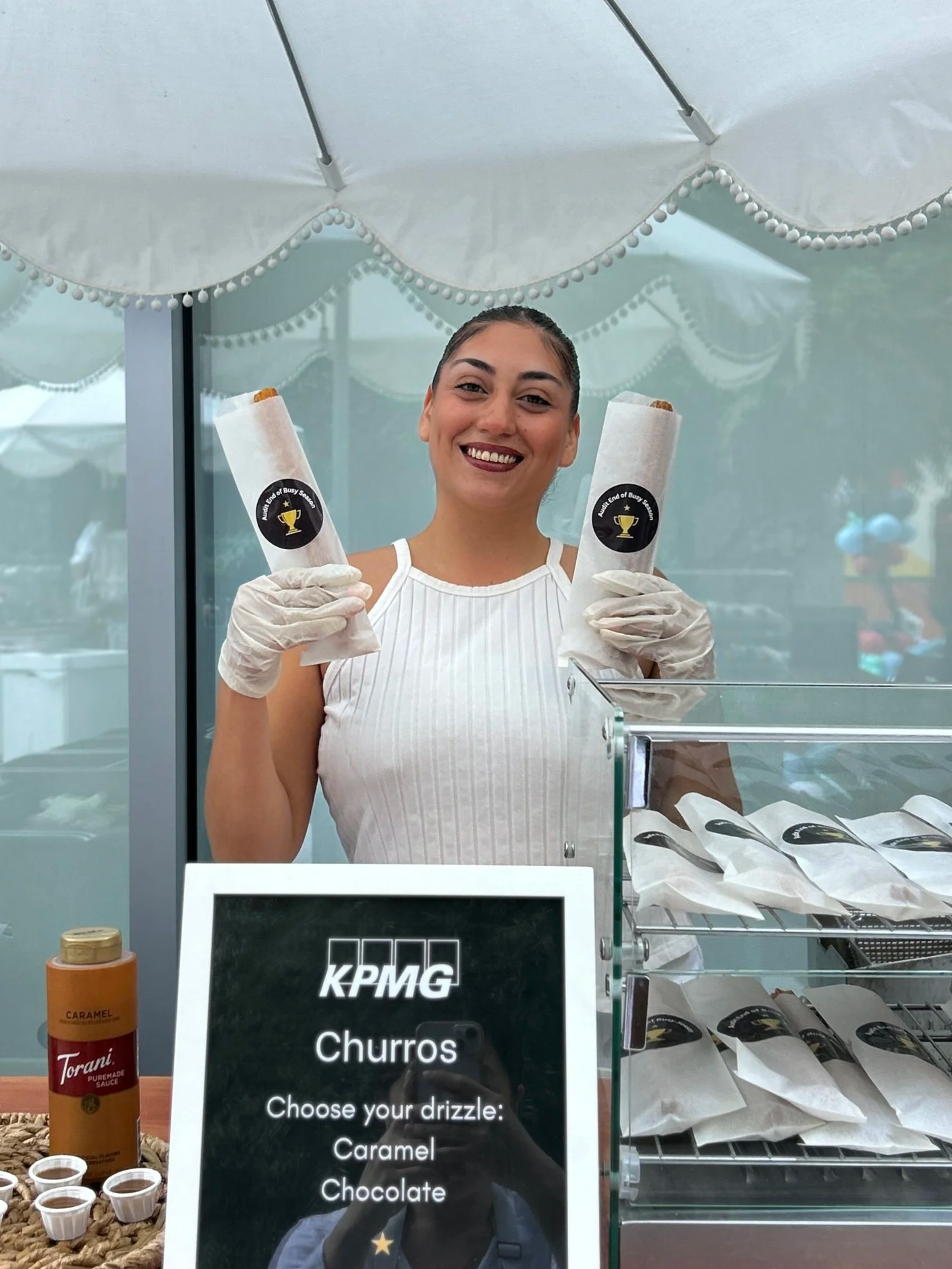 A Jolly Sheep attendant serving churros at a KPMG employee event