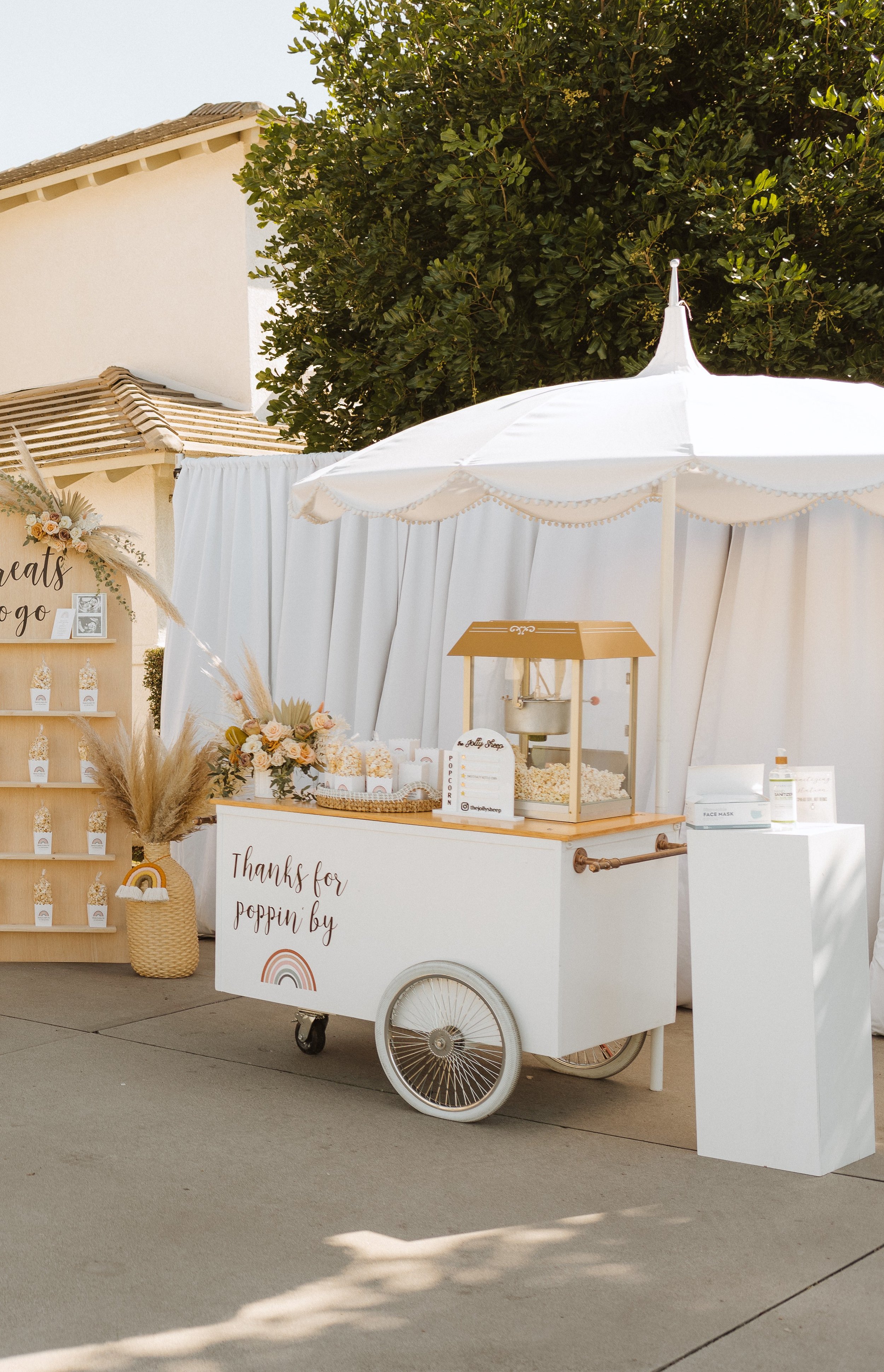 The Jolly Sheep popcorn cart set up at a drive by baby shower