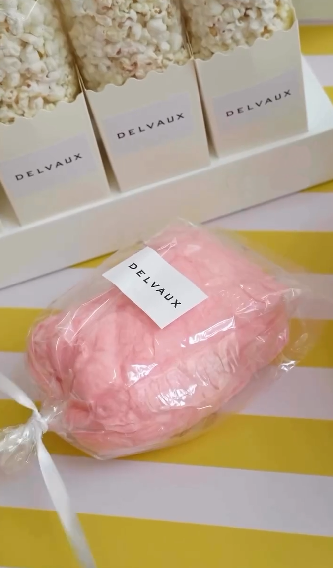 a packaged cotton candy on a stick with a custom label on it