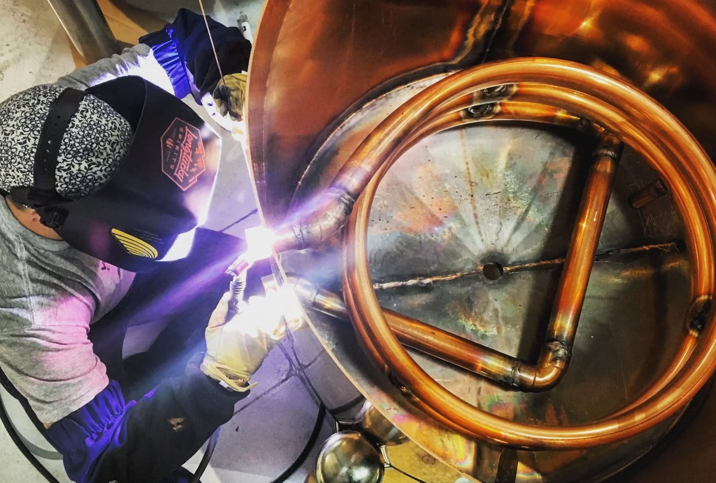 Here's a throwback of @hkw3 welding the steam coil into one of our beautiful copper pot stills. HK might be in Michigan, but his stills create the essence of our spirits and our brand. @jythespiritsguy will be discussing the history of Abbott &amp; W