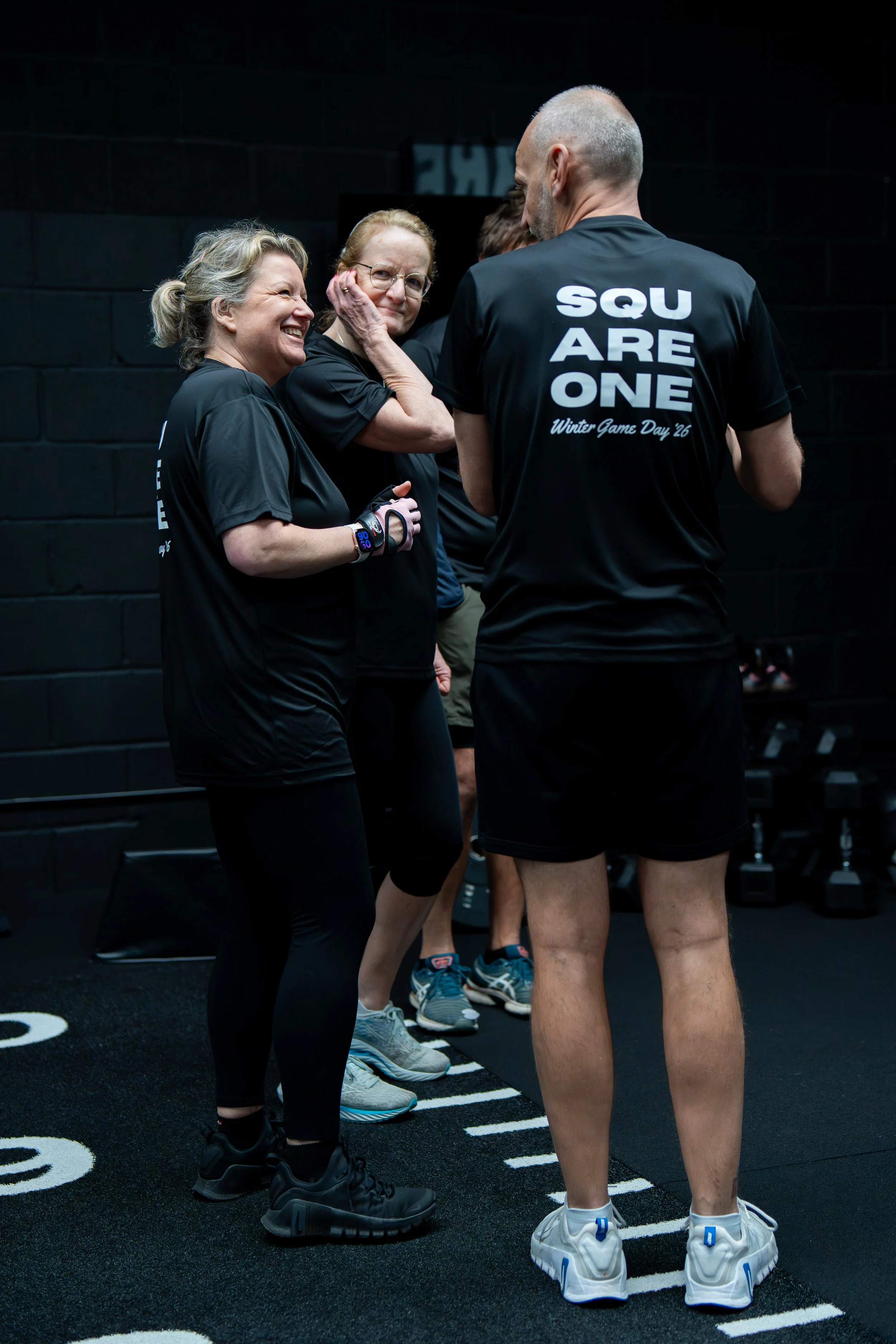 Members having a giggle and a chat during a small group personal training session at Square One in Wimborne Dorset.