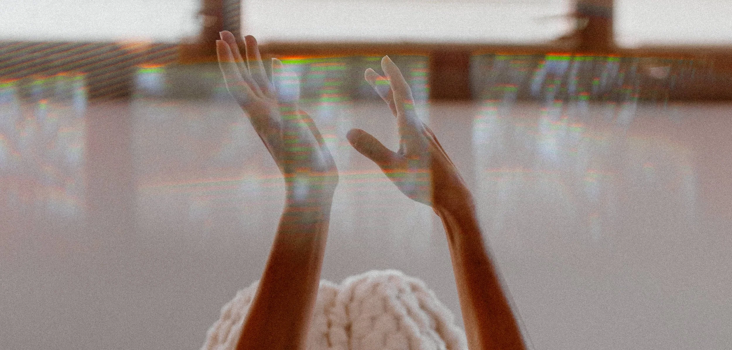 Woman's hands in the air during psychedelic journey