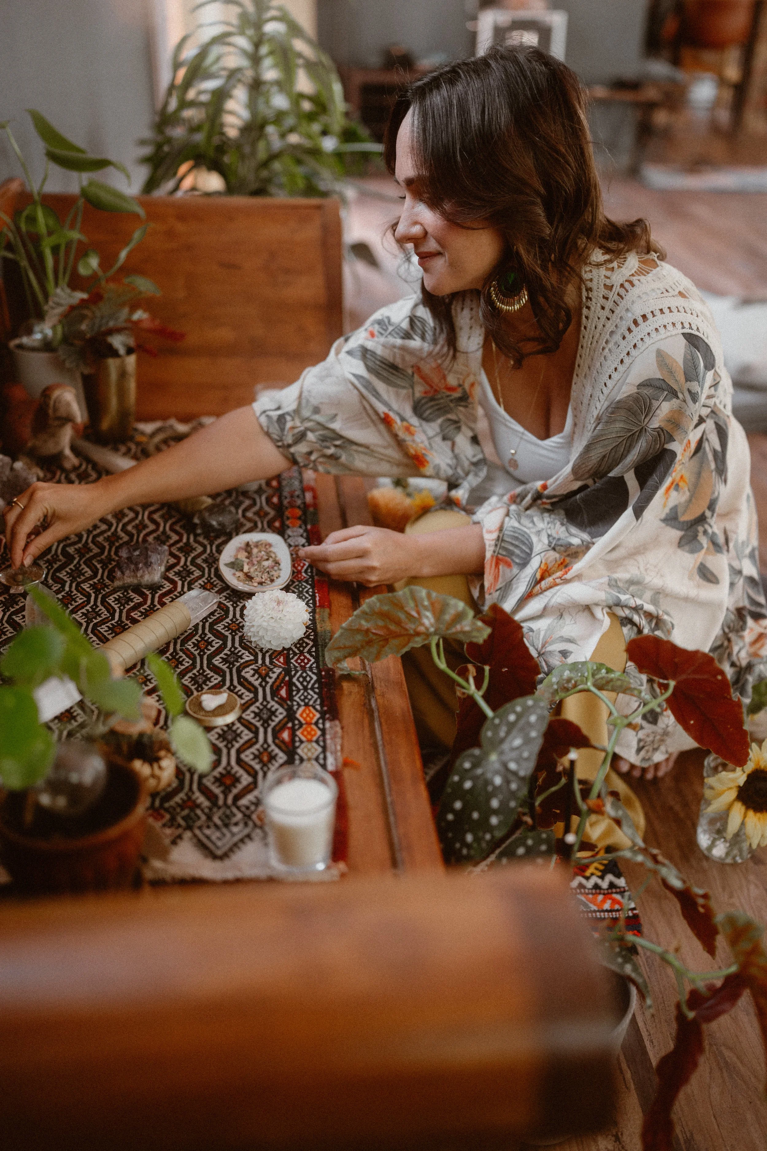 Dori Lewis arranging items on a wooden altar.