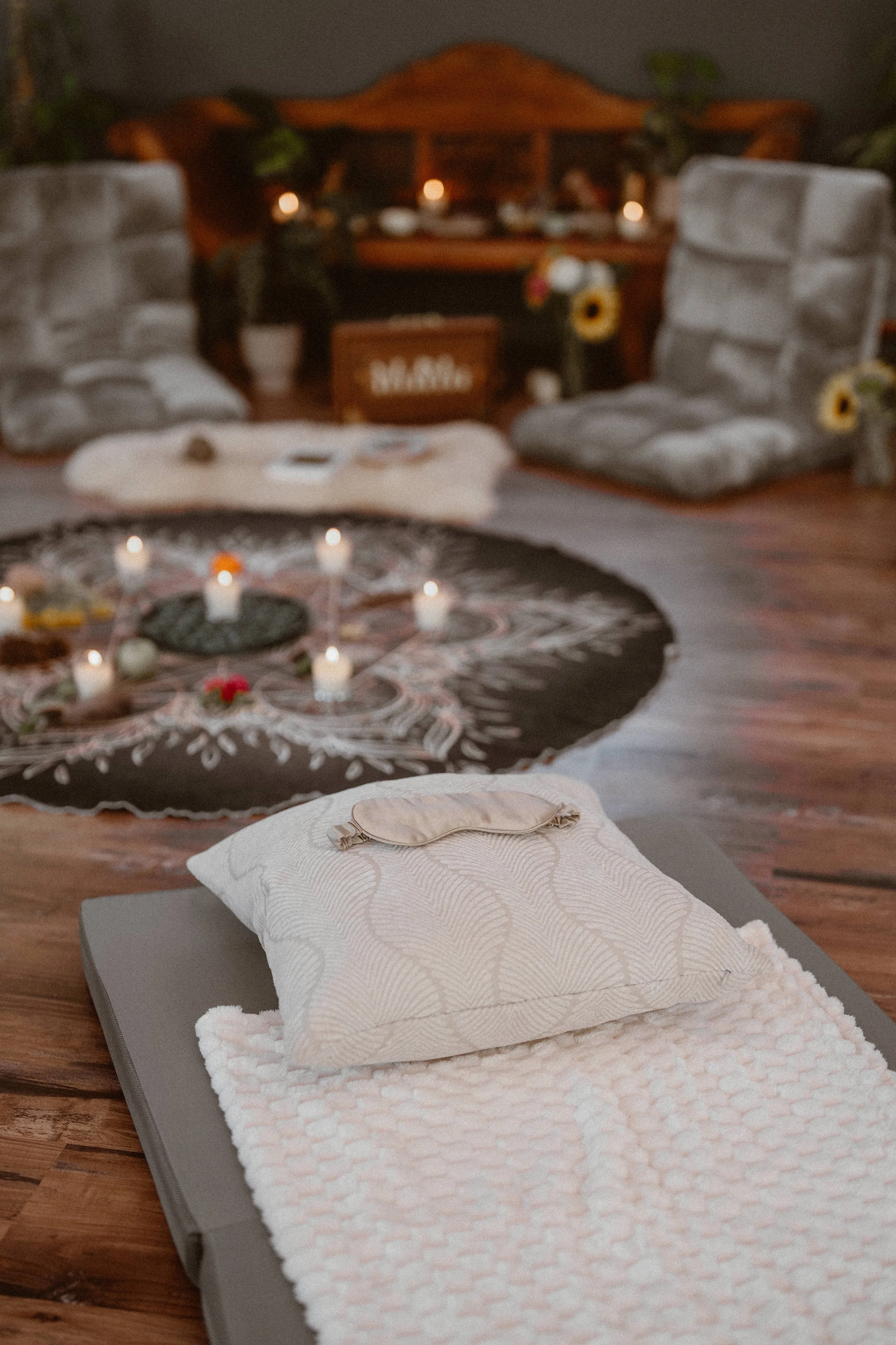 Cushions and pillows arranged around a circular altar in preparation for psilocybin therapy.