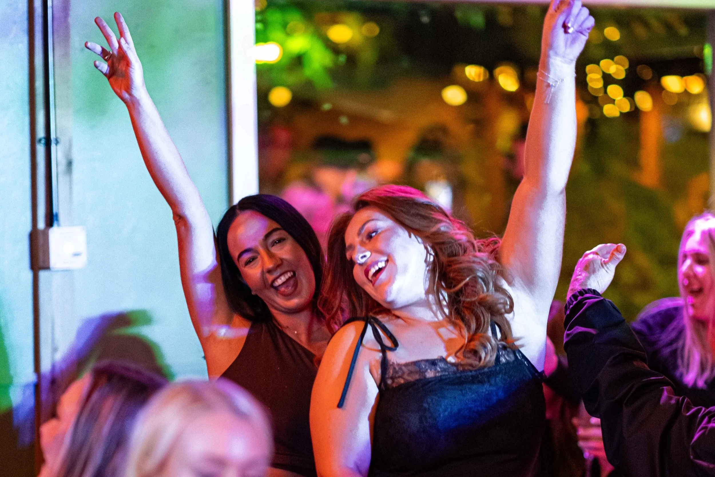 Group of girls dancing at The Lawn Club's bottomless brunch parties.