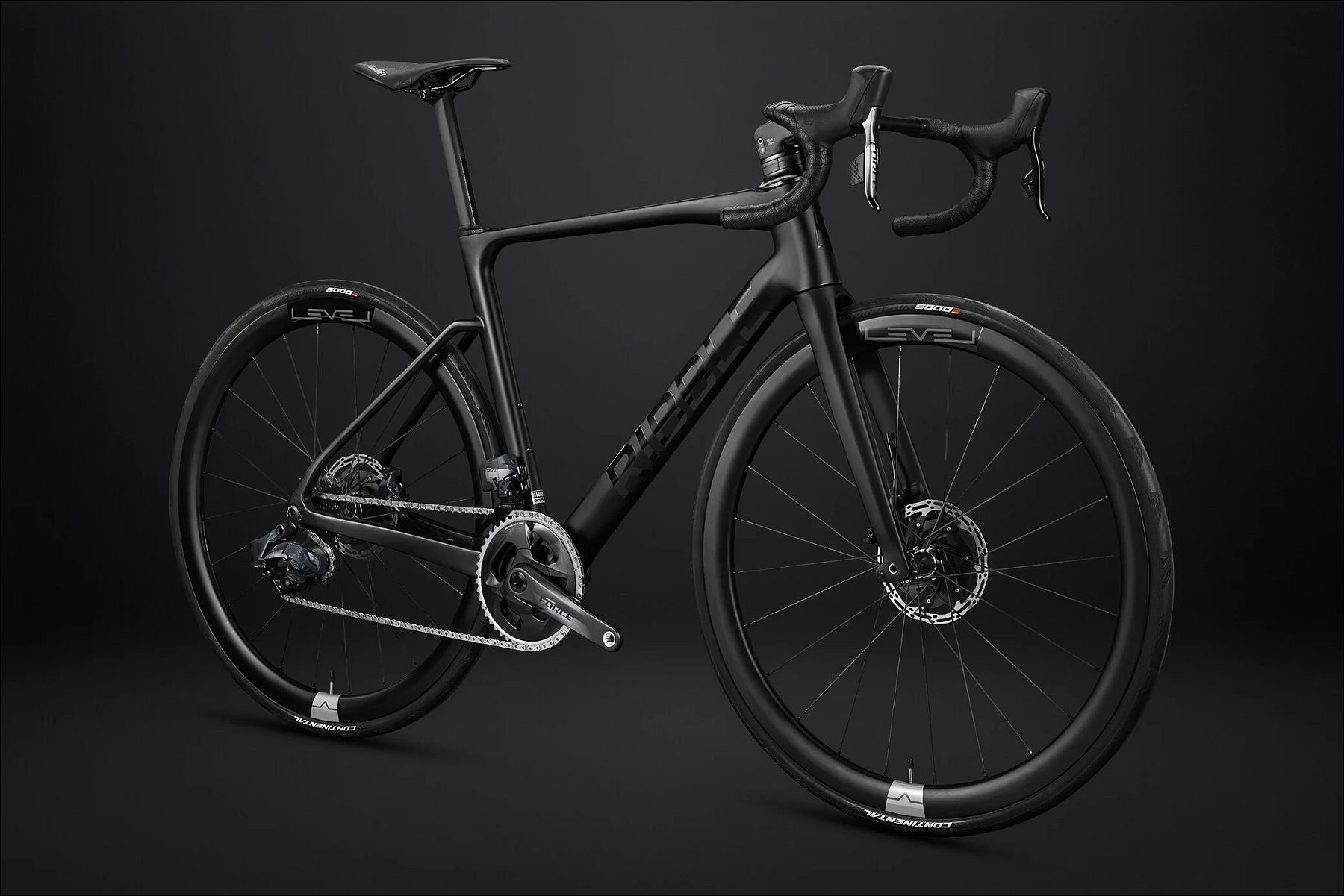 Black road bike photographed in a dark studio.