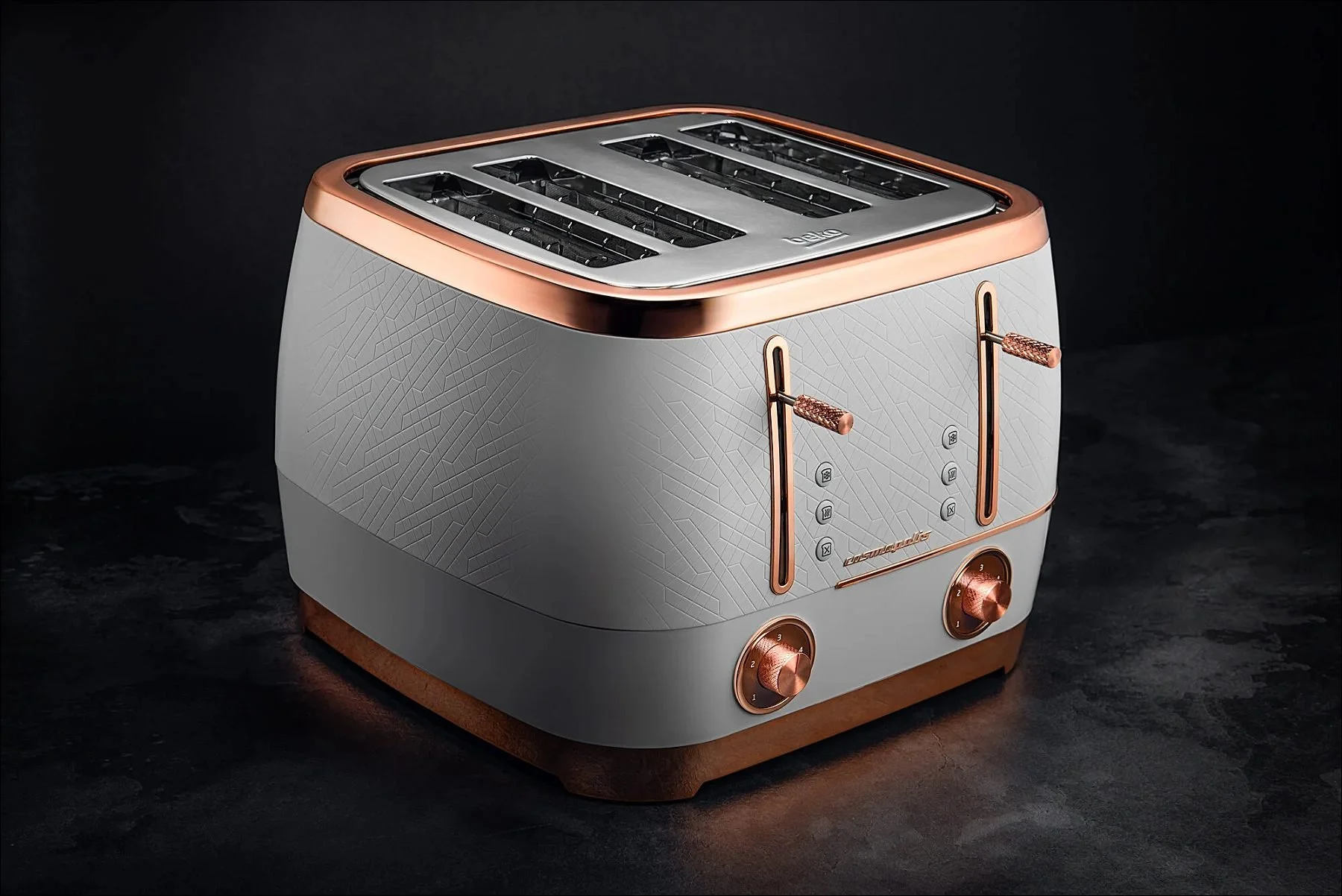 Stylish metallic toaster with copper accents on a dark reflective surface