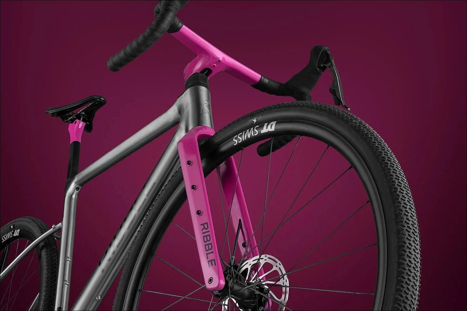 Pink and grey  bike product photograph against a bold magenta background