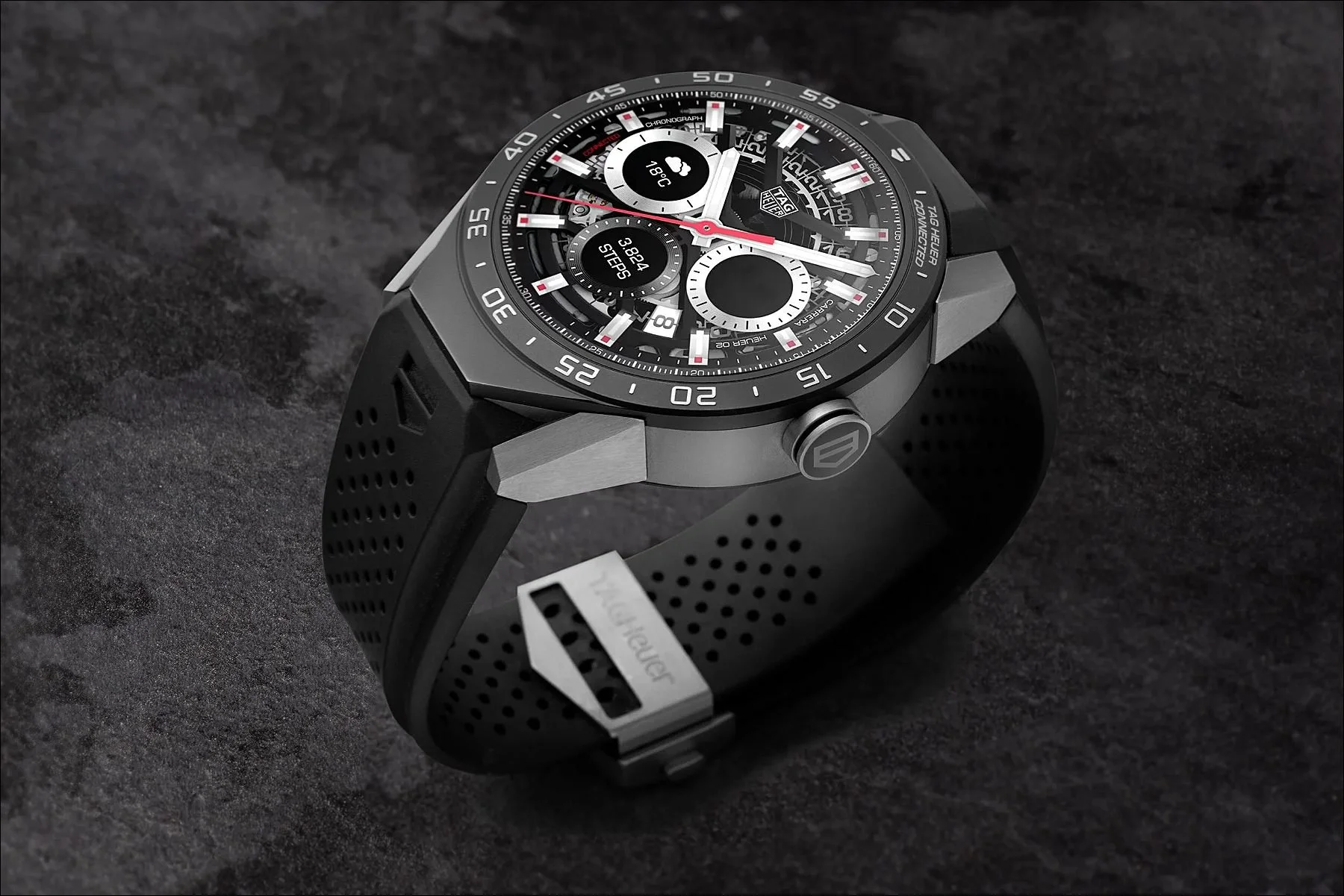 Black multi-dial wristwatch with red accents displayed on a dark textured background.