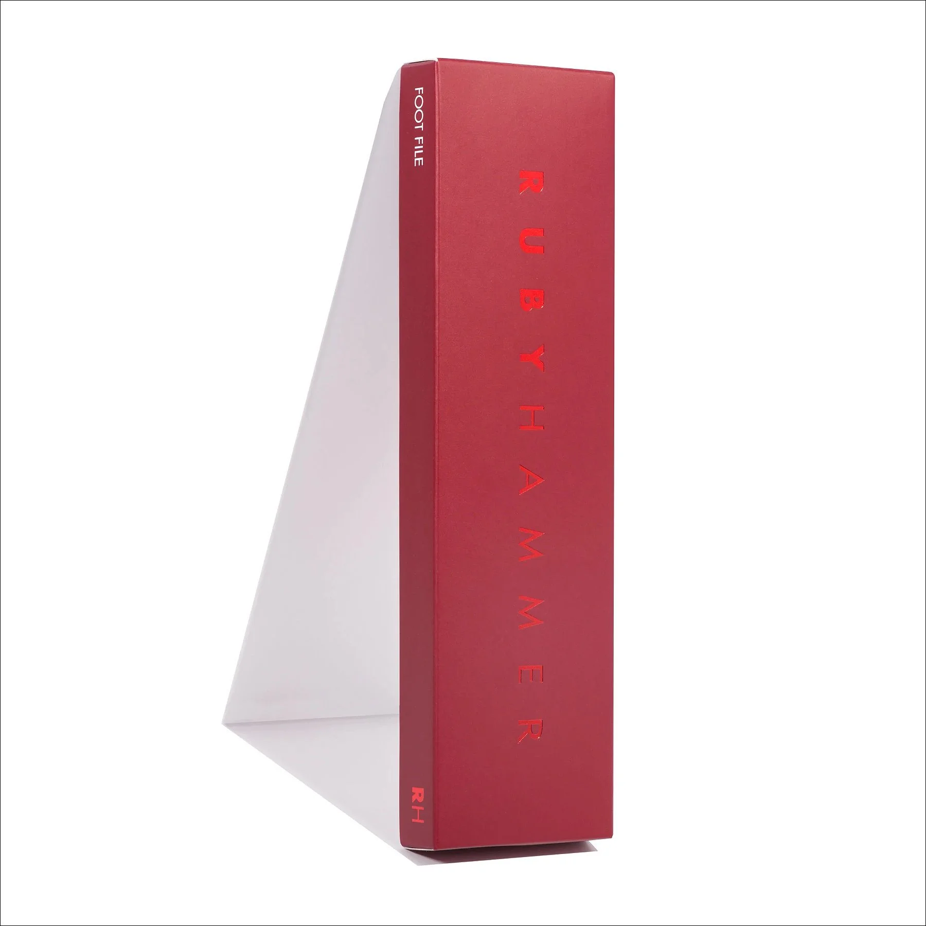 Red rectangular object with a subtle gradient and vertical ridges, displayed upright on a white stand against a white background.