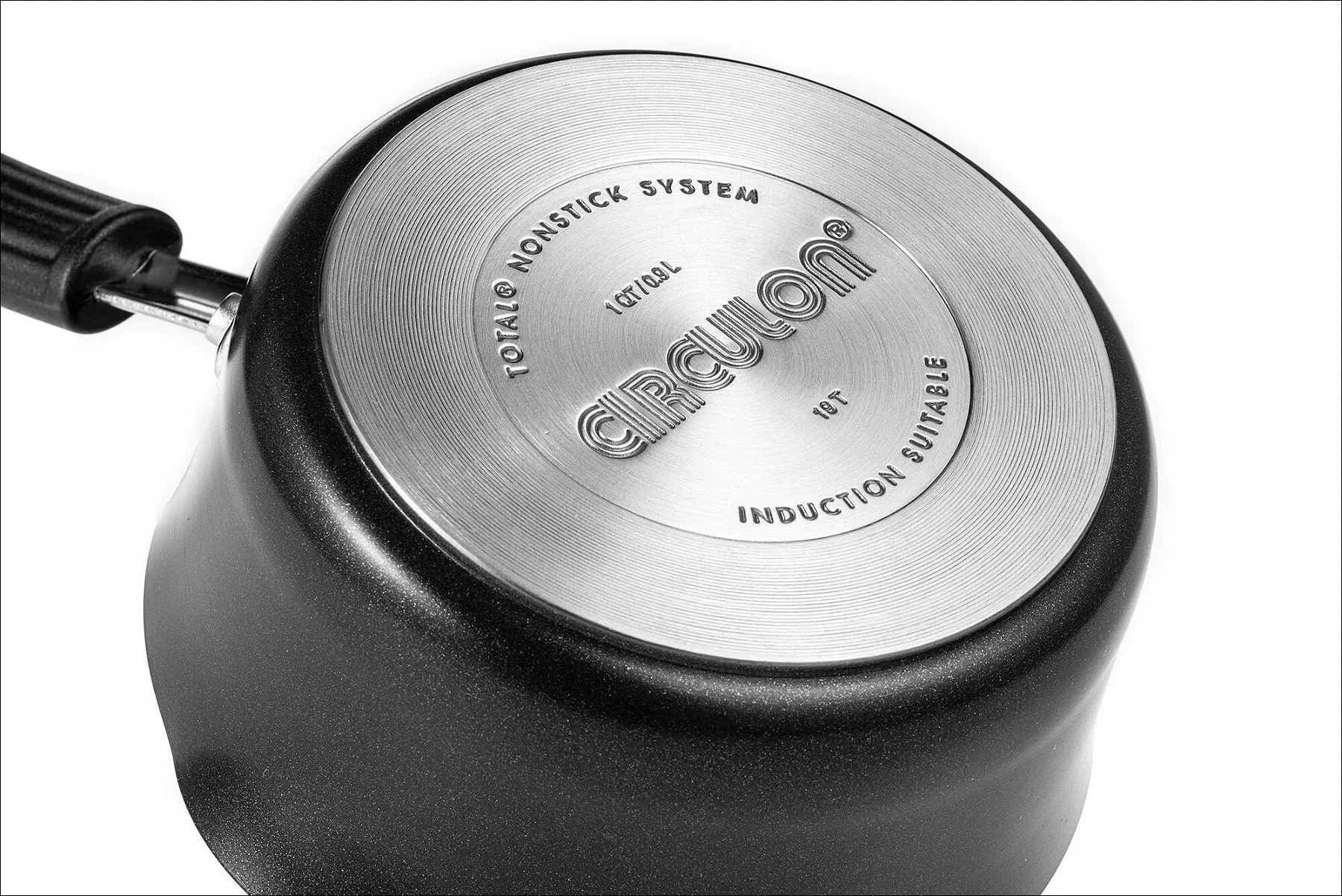 Metal circular object with engraved text and a small handle against a white background