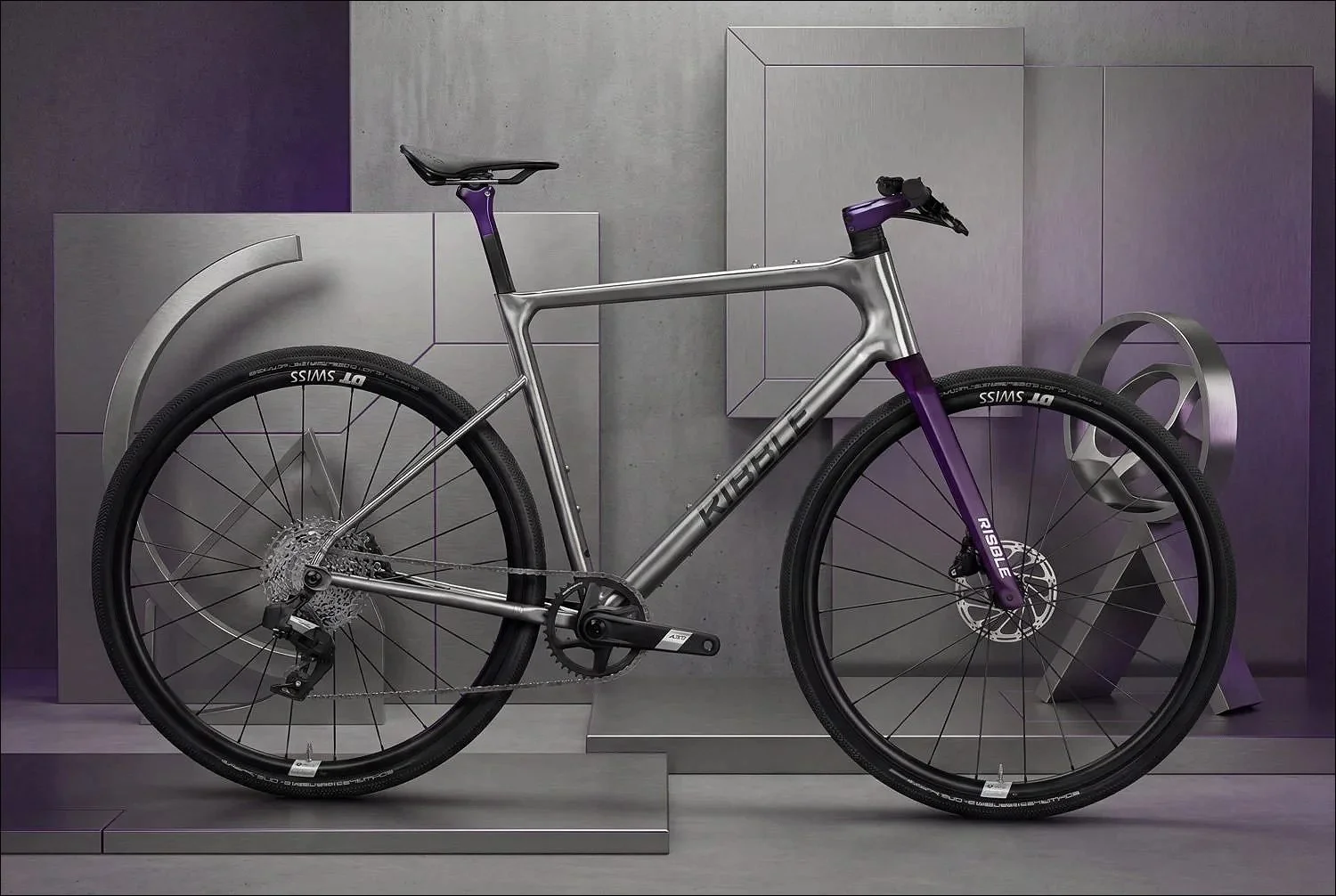 Grey road bike displayed against a modern minimalist grey studio backdrop.