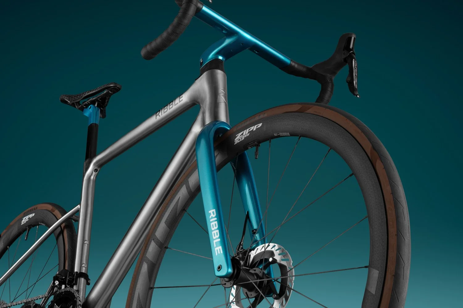 Three-quarter view of the Ribble Allroad's integrated cockpit and metallic teal fork on a titanium-colored frame.