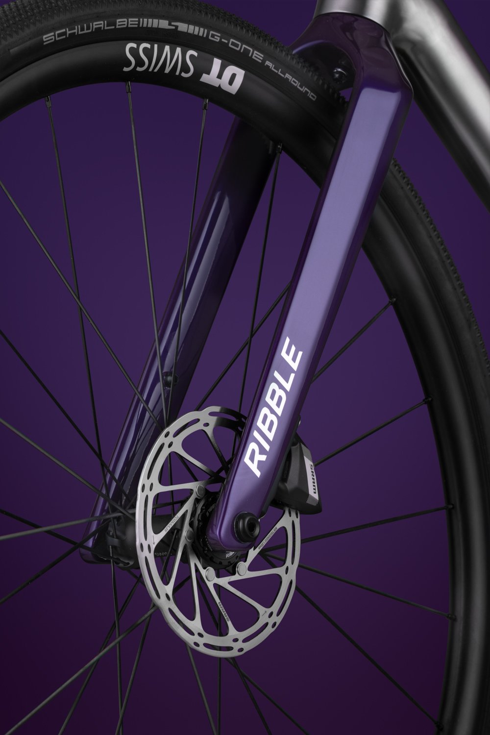 Close-up detail of a Ribble  fork in a purple finish with internal cable routing.