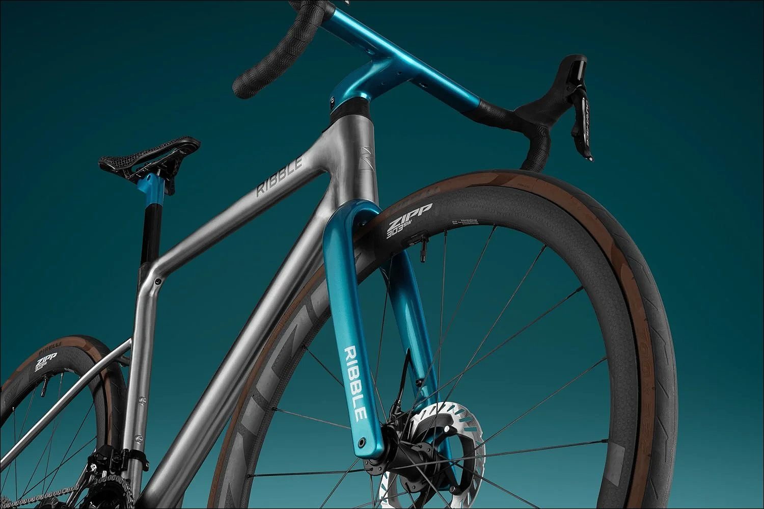 Grey and teal  bike product photograph against a teal blue background