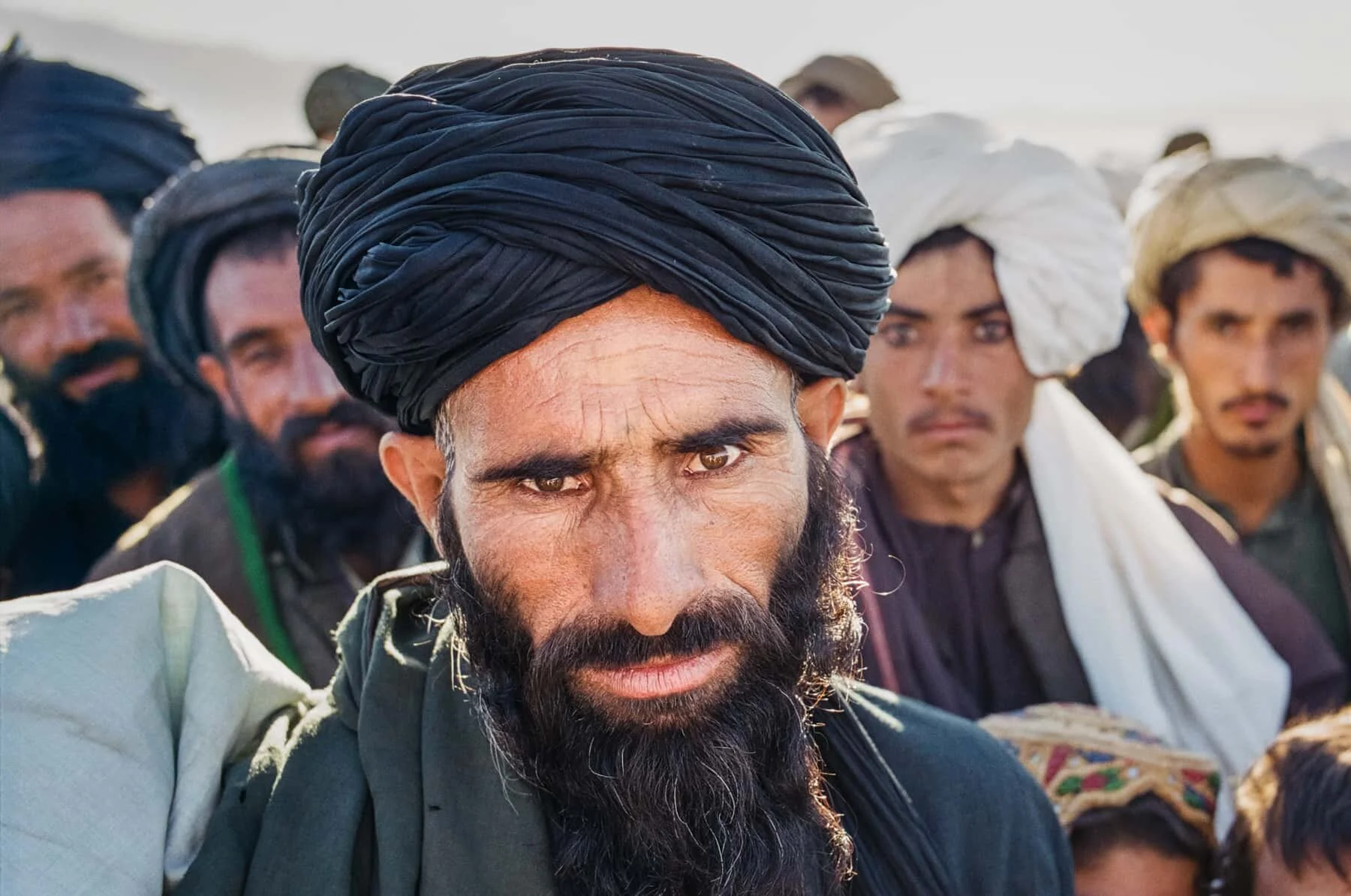 Afghan men looking into the camera.