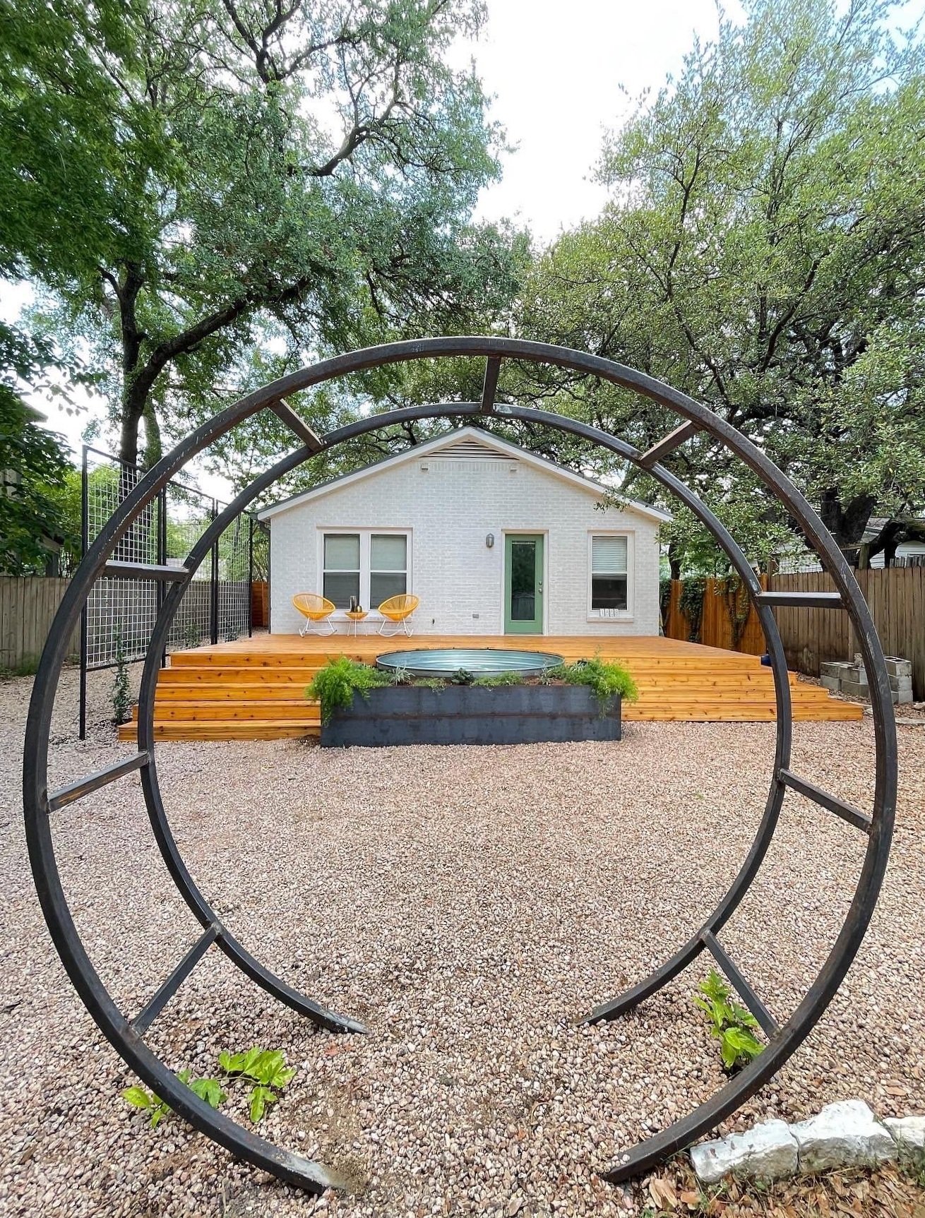 This is a steel moon gate used to elevate your outdoor space and add vertical interest to your garden. Fabricated by Mathis Designs in the Texas Hill Country