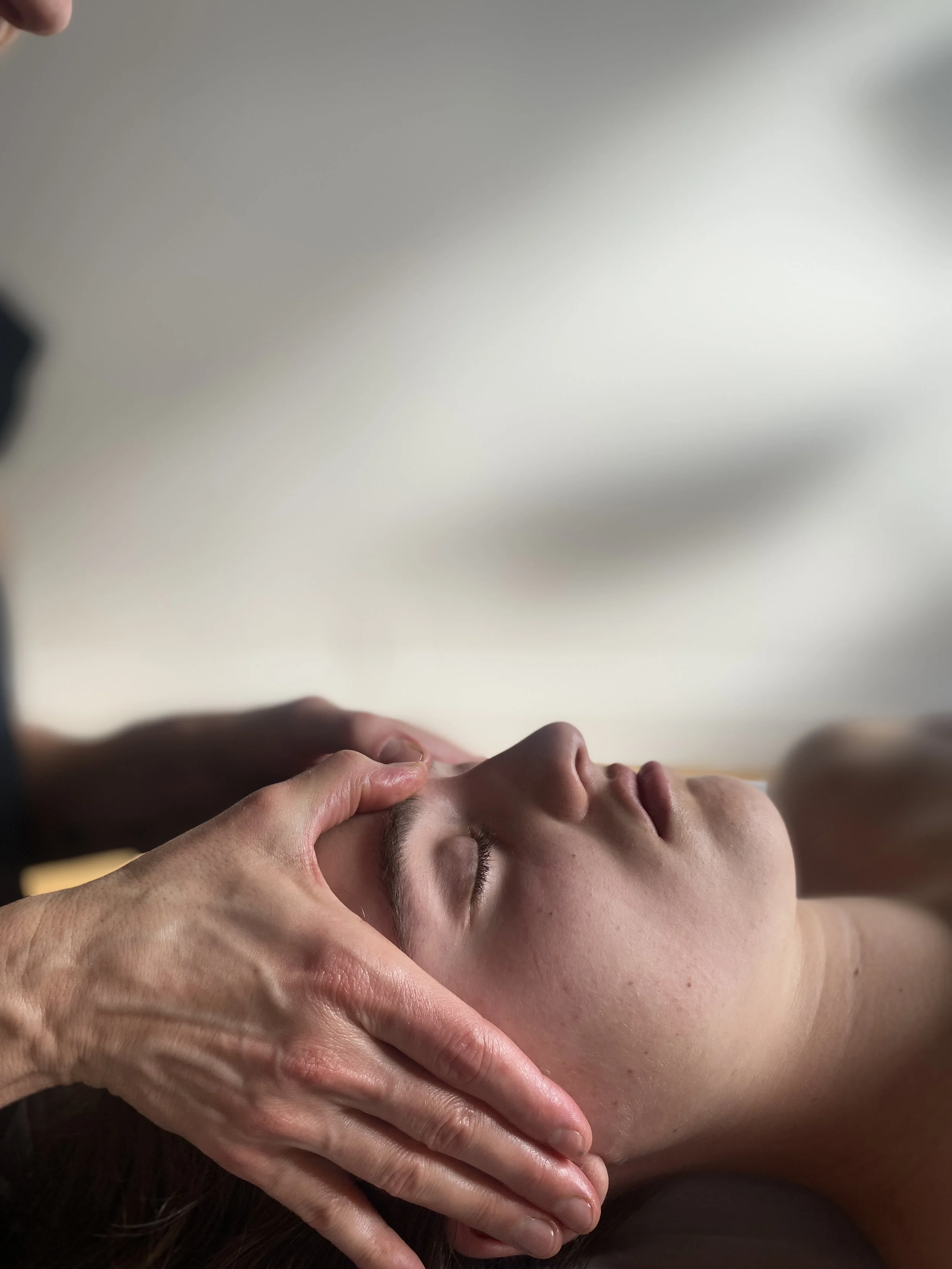 breath work and gentle scalp massage. image of person receiving a scalp  massage