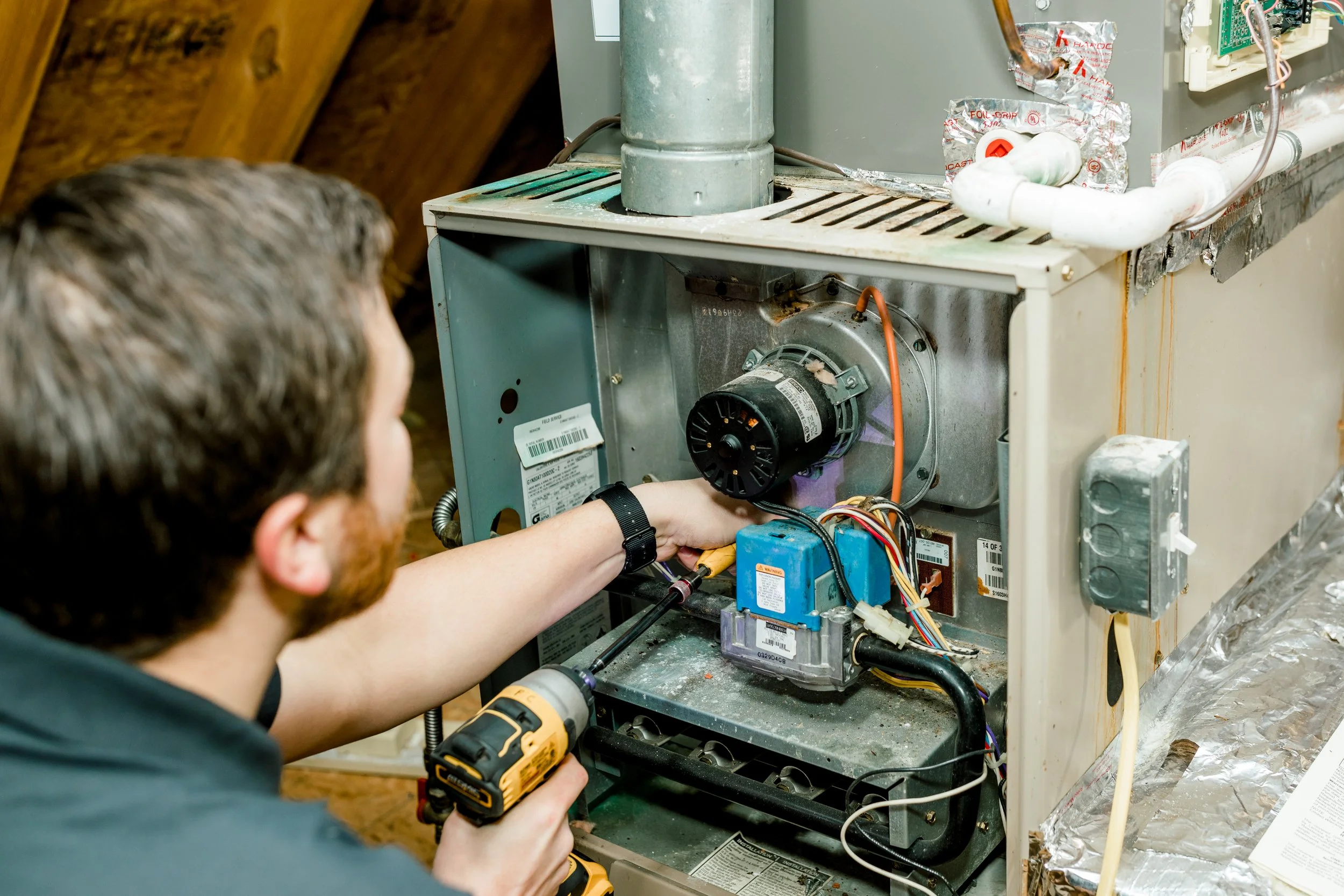 tech servicing a furnace