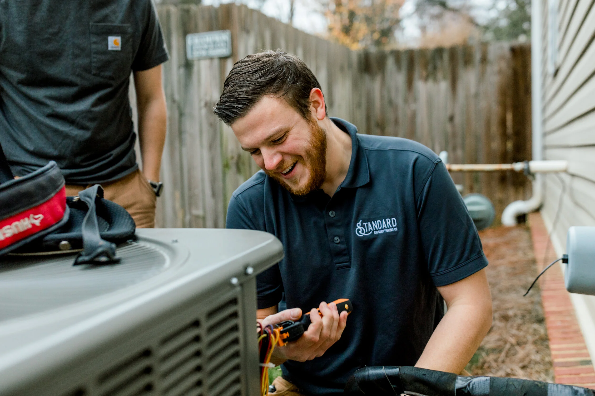 technician working on an AC unit.
