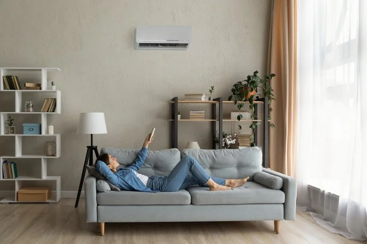 woman adjusting mini split temperature