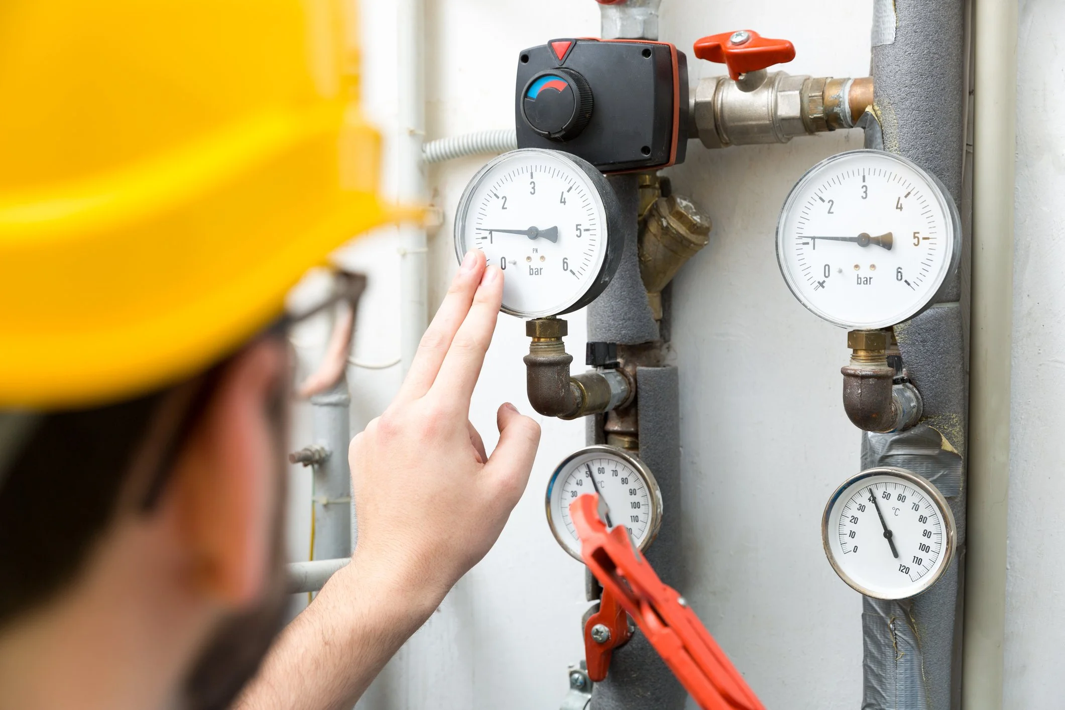 Technician checking gas line pressure