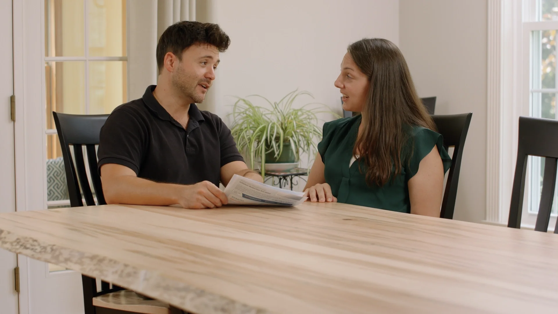HVAC technician advising a customer