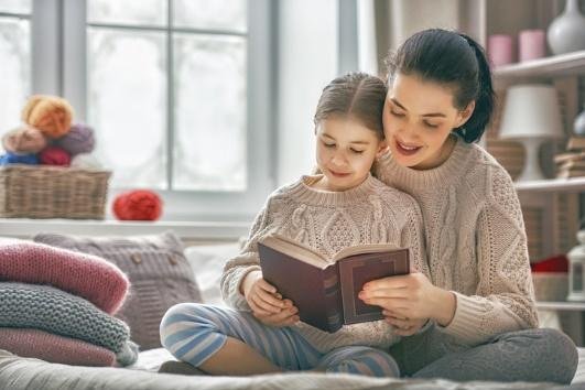 mother and daughter reading a book