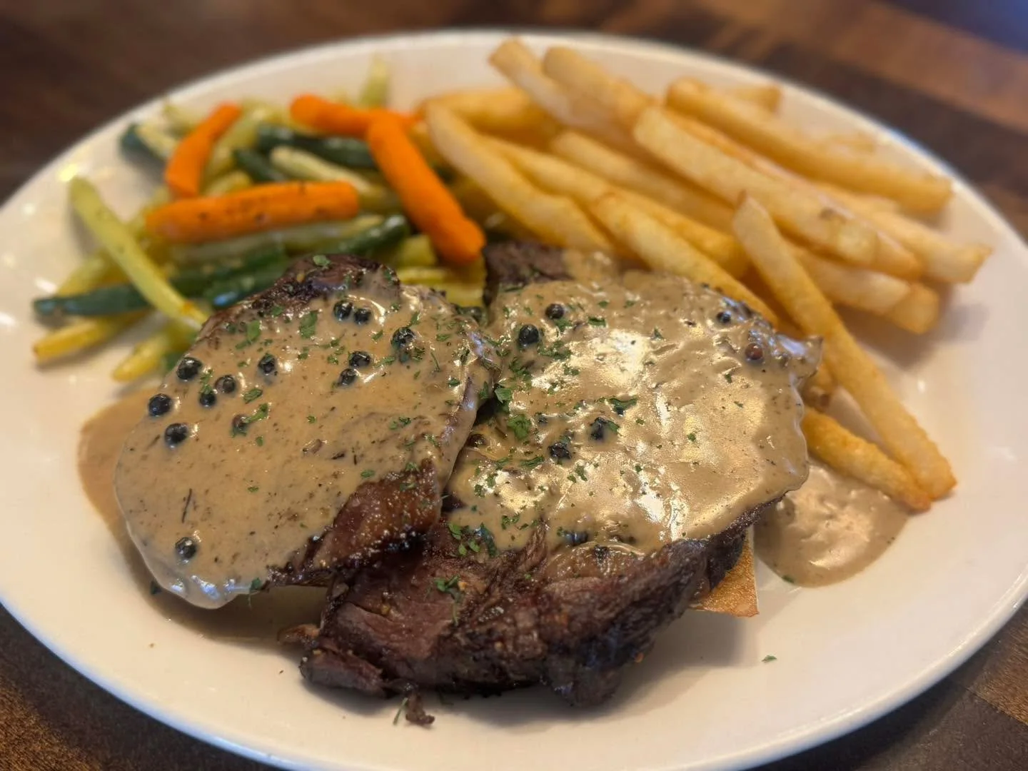 Open Faced Prime Rib Sandwich with a Bourbon Peppercorn sauce with veggies and French fries. 

Served 11-2 pm on our Epic Lunch Feature!