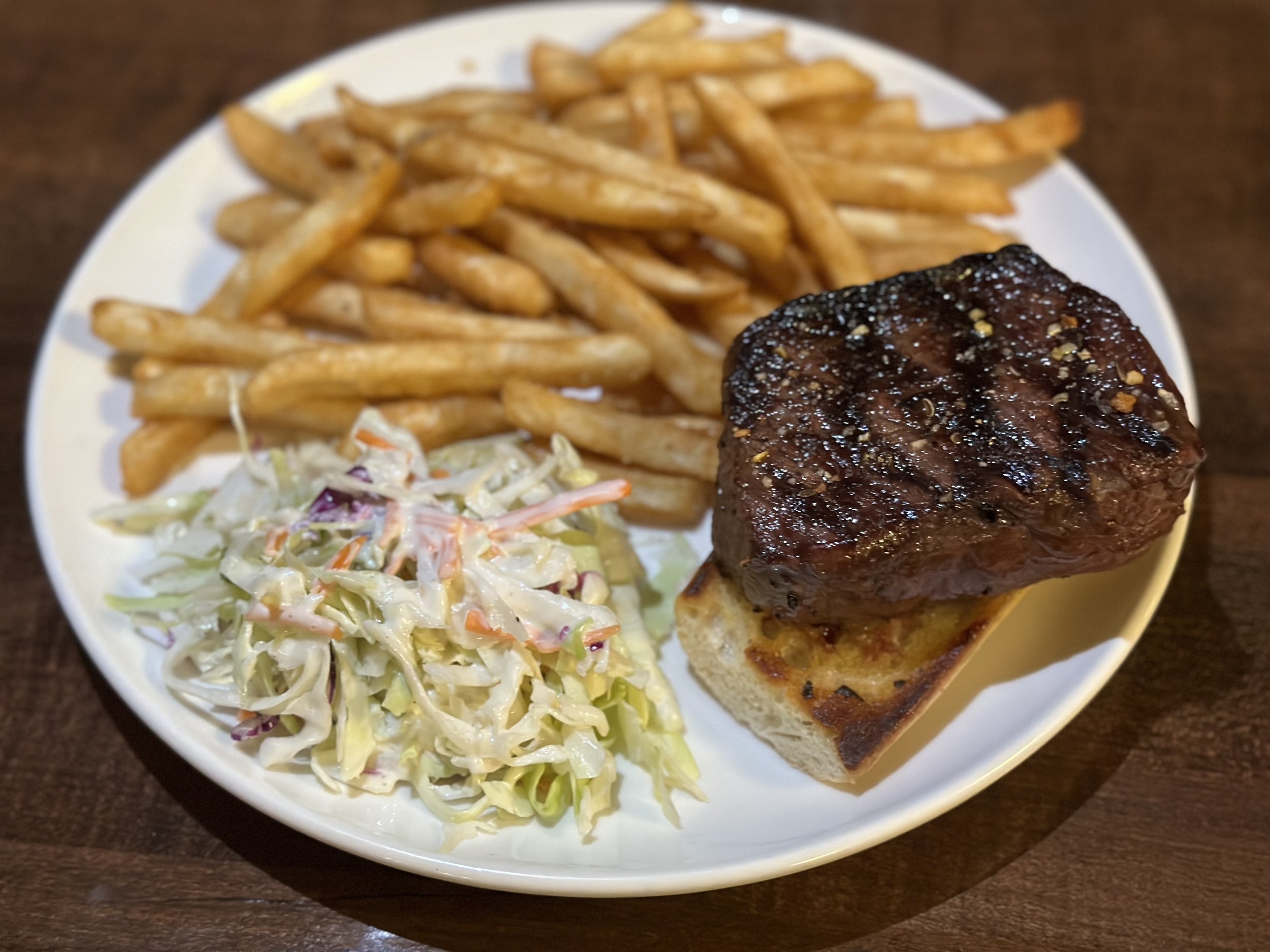 Steak sandwich with fries and house slaw