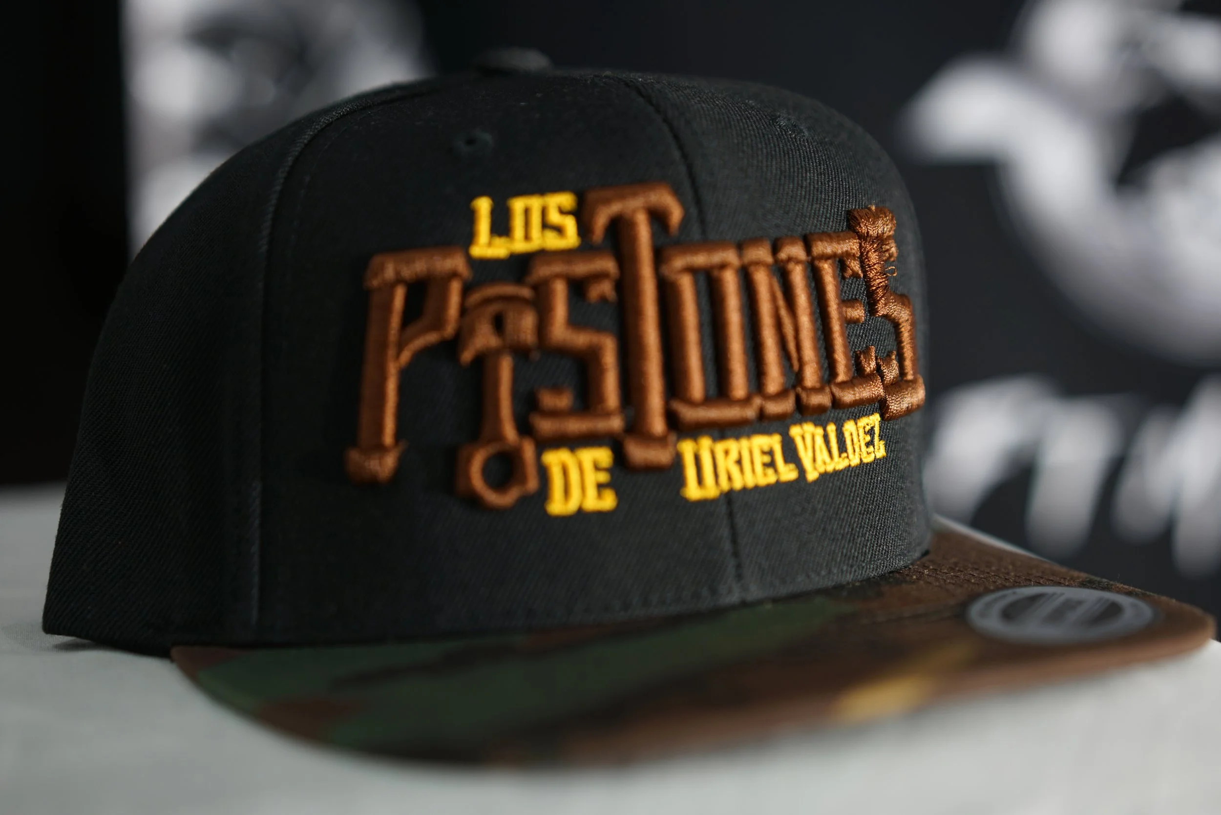 Los Pistones De Uriel Valdez Cap (Brown, Black & Military).
