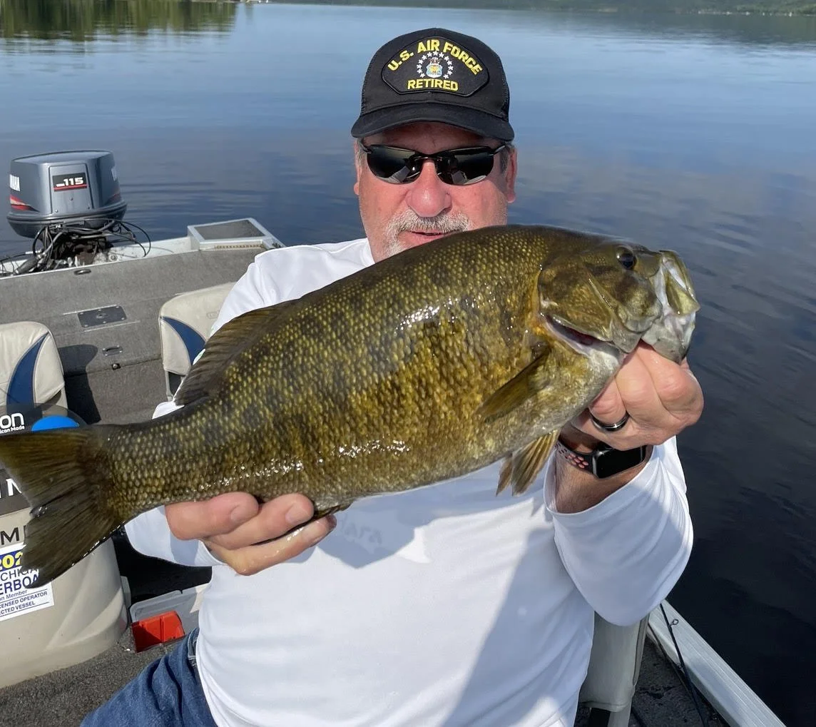 Bass Fishing Guide Services - Fishing Guide - Calumet, MI - wearing a "U.S. Air Force Retired" cap
