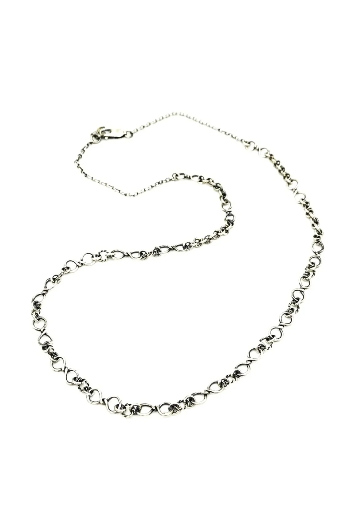 Handmade sterling silver chain with uniquely crafted, slightly twisted oval links forming an elegant, lightweight design.