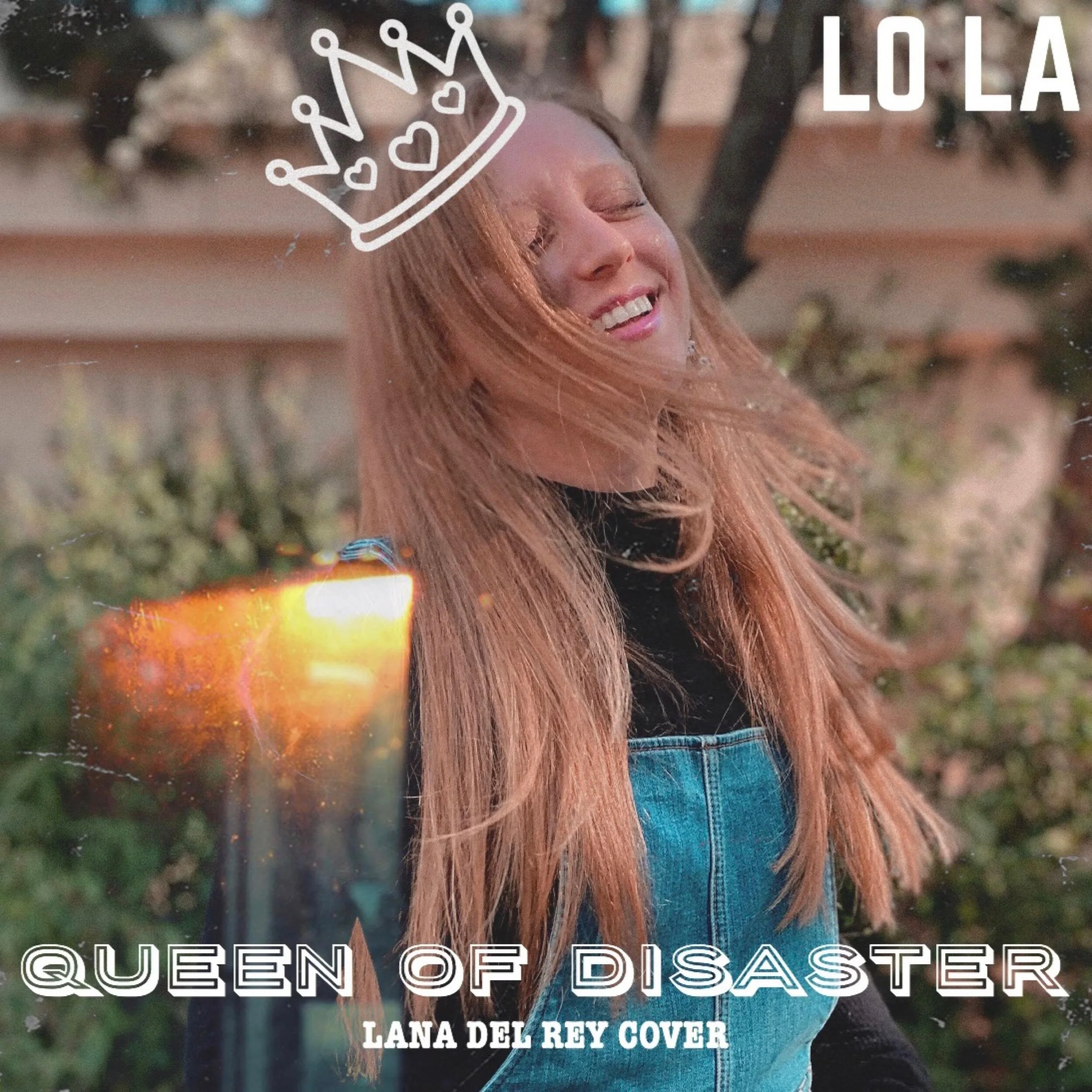Lola Violet with long red hair smiling with eyes closed outdoors. She is wearing a denim vest and a black top. There is a cartoon crown drawn on her head and text overlay that reads 'Lo La,' 'Queen of Disaster,' and 'Lana Del Rey Cover'.
