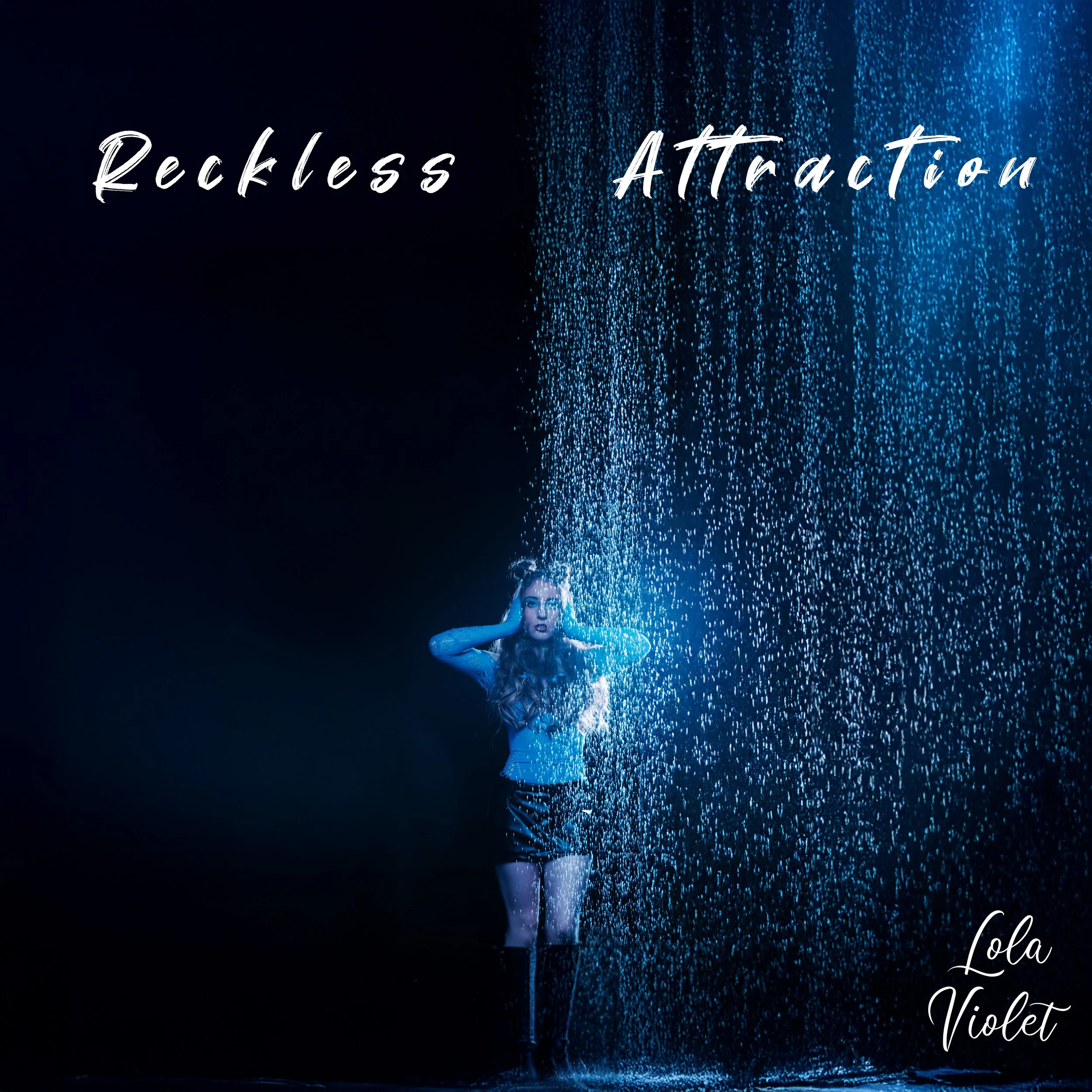 Lola Violet stands under a waterfall with her hands on her ears, illuminated by blue light, with the words "Reckless Attraction" and "Lola Violet" written on the image.