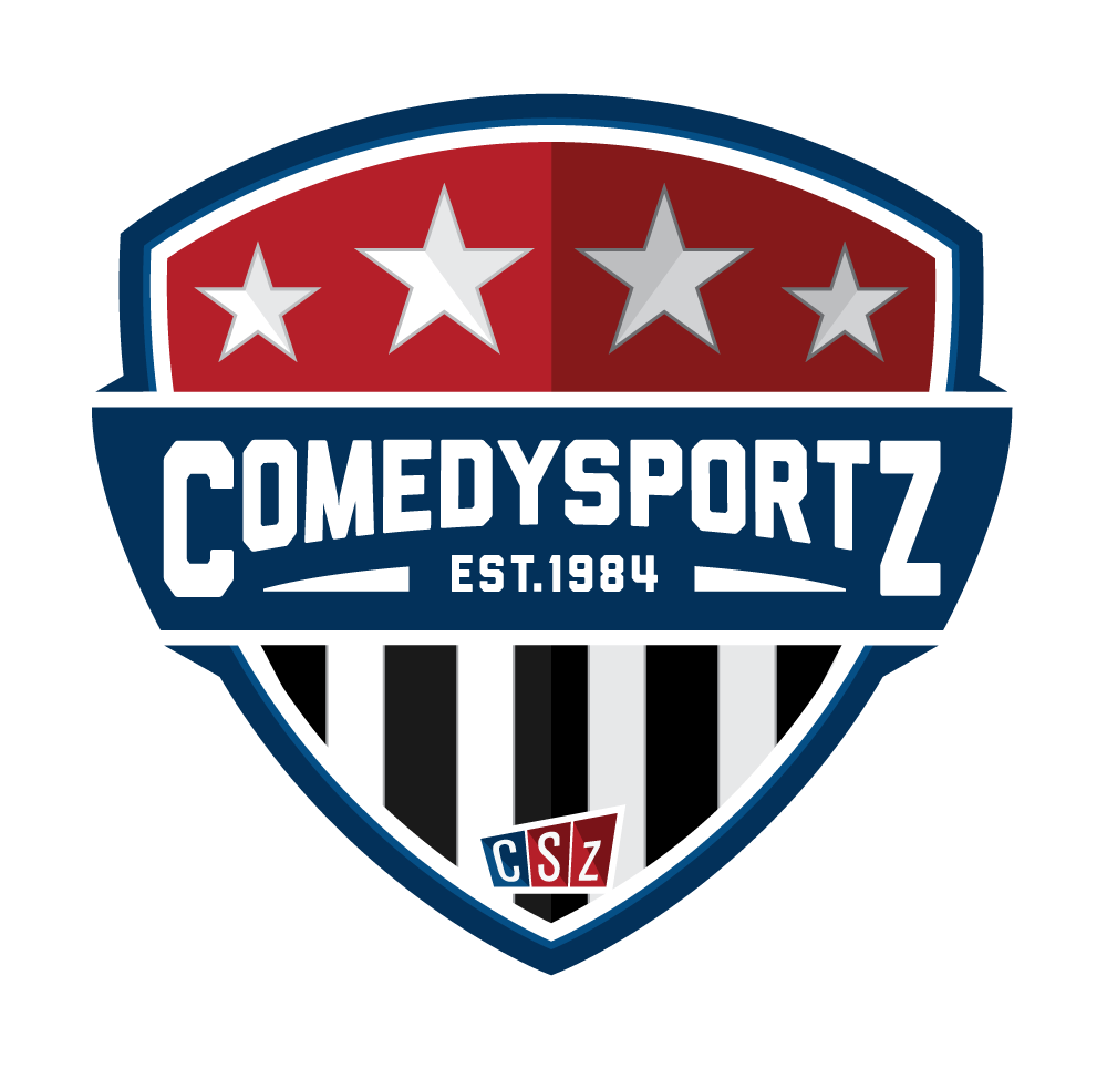 A sports team logo for COMEDYSPORTZ, established in 1984, featuring a shield with stars and black and white stripes.