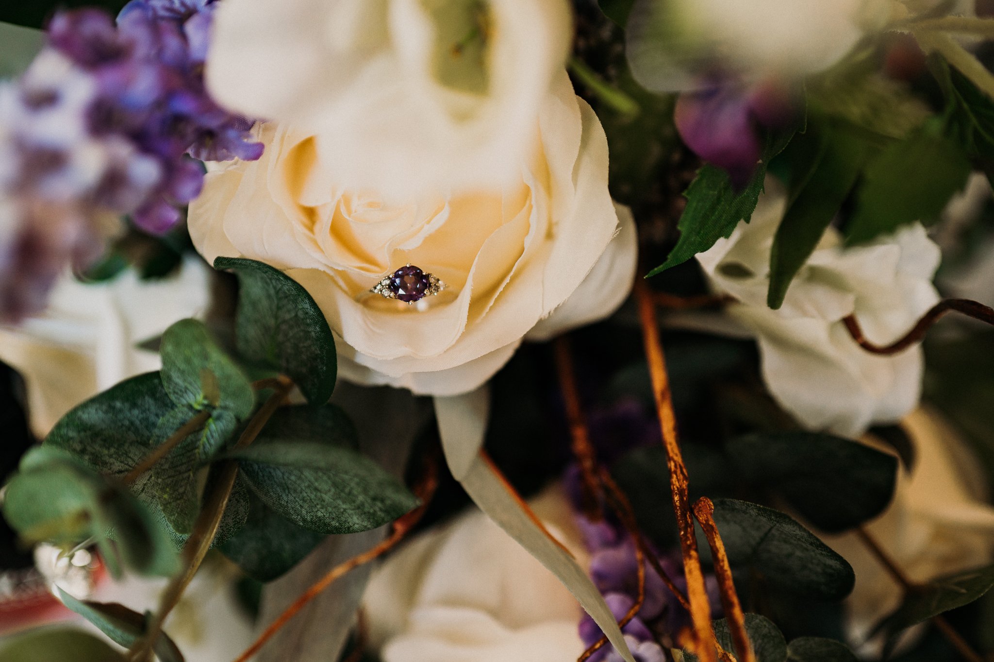 The engagement ring nestled amongst the petals of a rose in the brides bouquet at Sneaton Castle, Whitby.