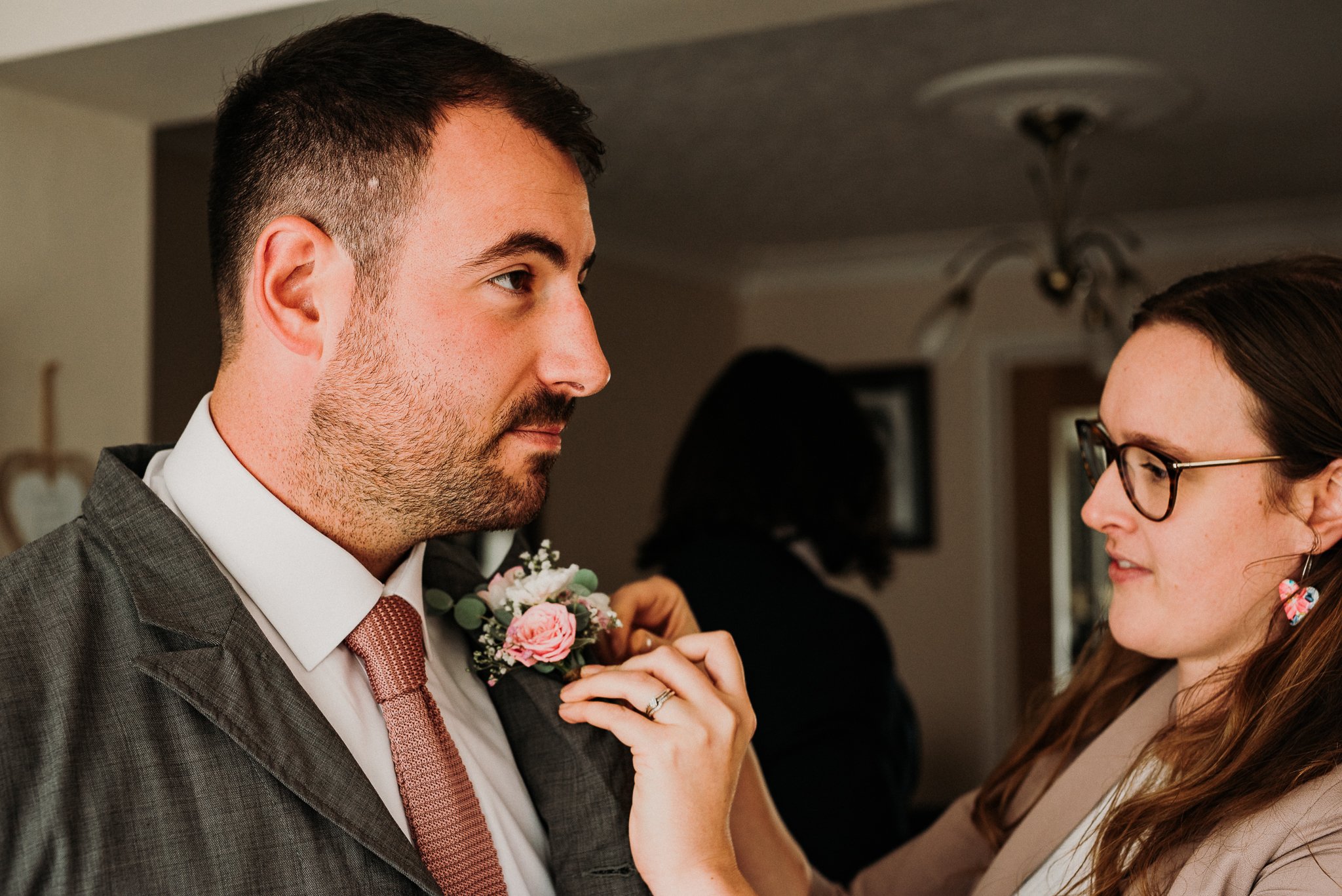 Amazing florist Rosemary Blooms attaches the grooms buttonhole for him on the morning of his wedding in the North East of England.