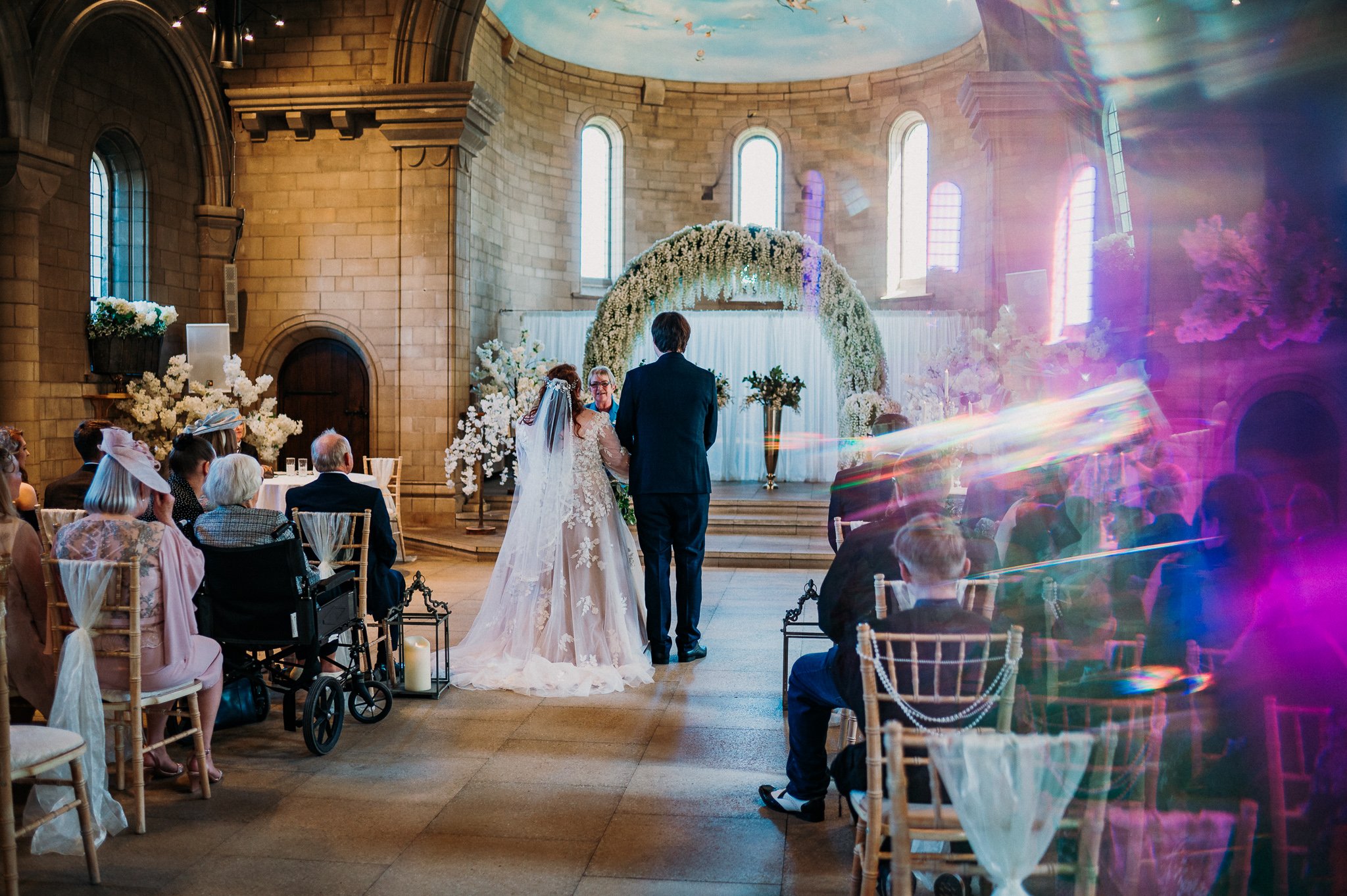 A prism photograph of the bride and groom at the top of the aisle during their wedding ceremony at Sneaton Castle, Whitby.