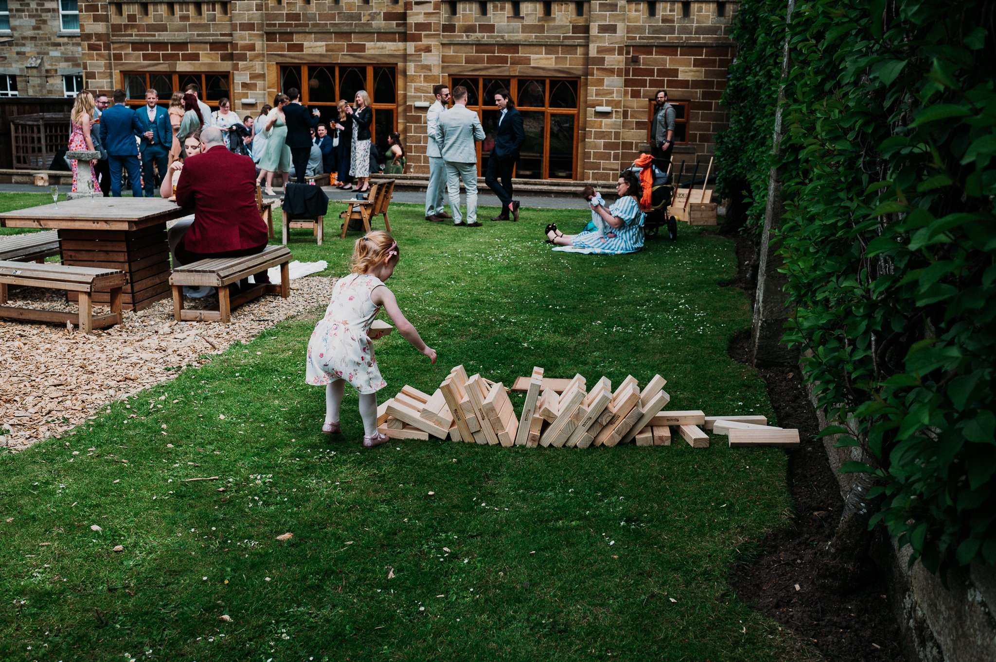 A young wedding guest knocks over the giant jenga set during the wedding at Sneaton Castle, North Yorkshire.